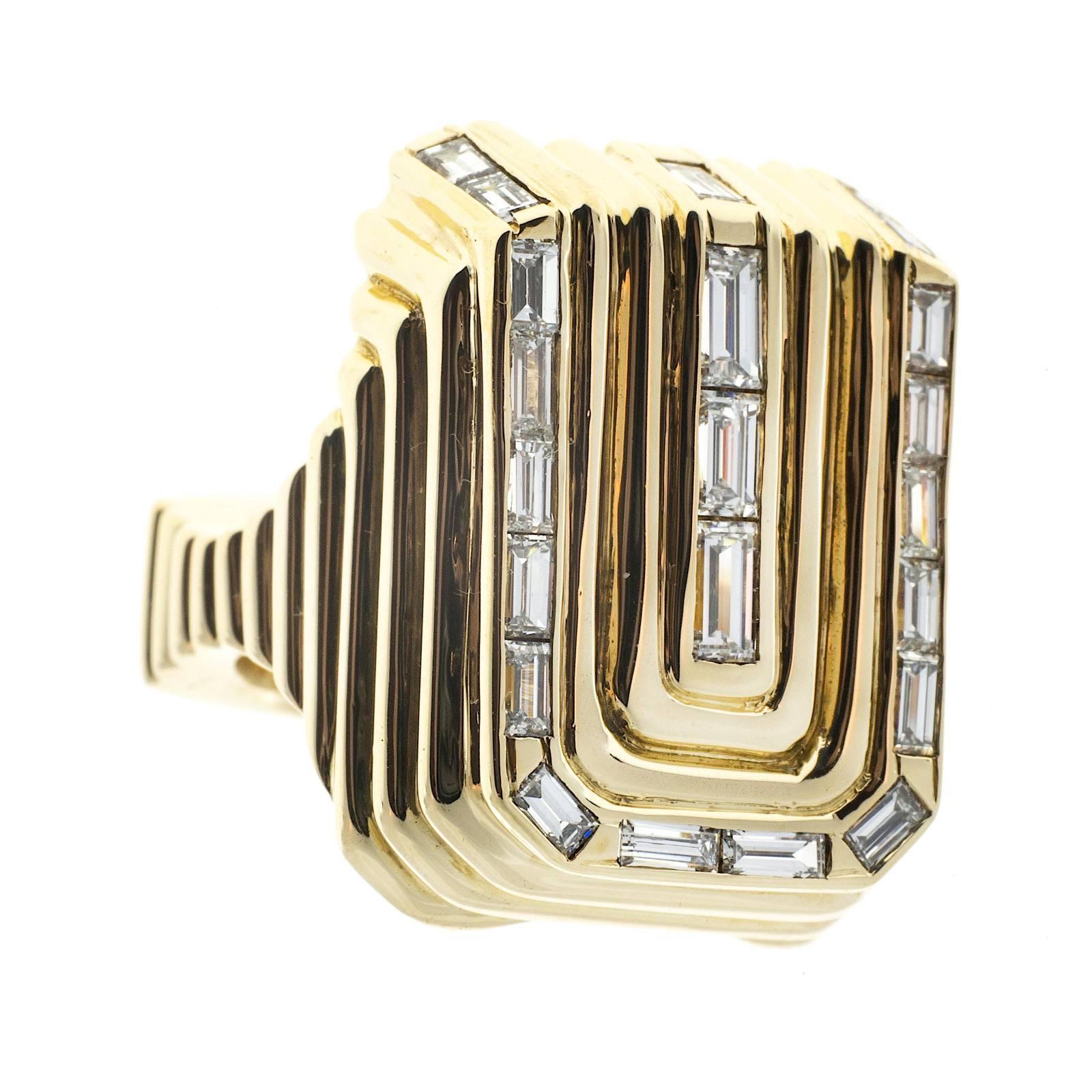 Large handmade oblong shape 3-D diamond ring, with a deep ribbed relief. The straight cut baguettes are channel set around the perimeter of the piece as well as down the center. Circa 1960-1970.

22 straight cut baguettes approx total weight