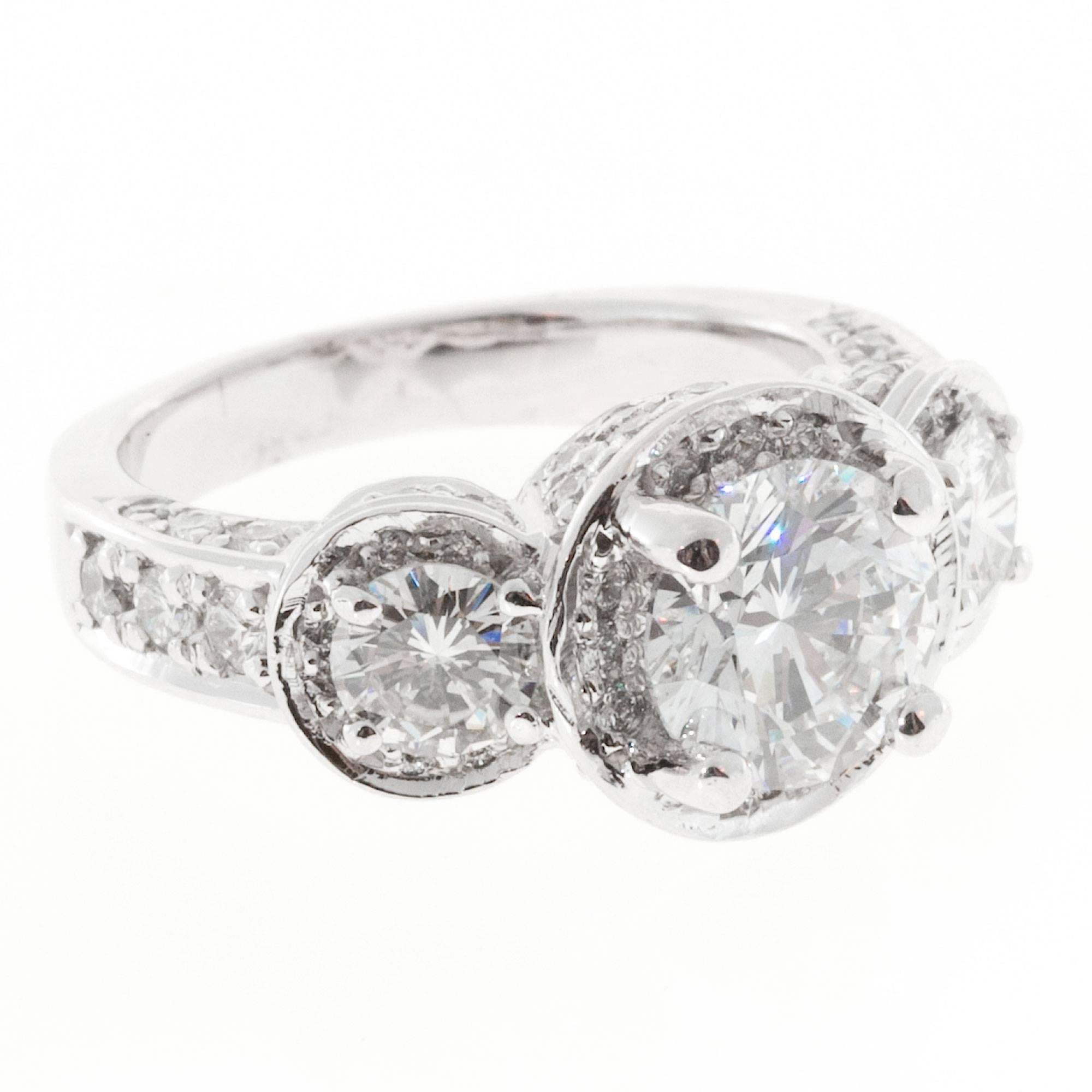 Gregg Ruth 3 stone Diamond pave platinum engagement ring.  Pave set with 72 full cut diamonds.

1 round diamond 1.65cts F, VS2 GIA Certified# 12163415
2 round diamonds approx.68cts. F, VS.
72 full cut diamonds, F, VS approx. 1.0cts total