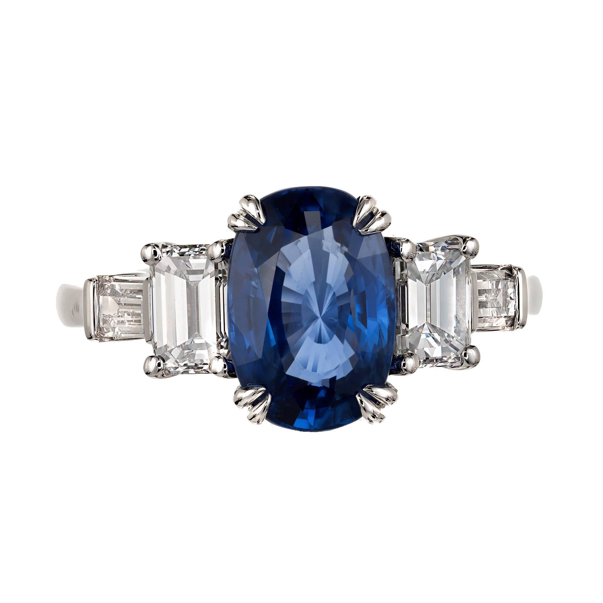 Bright blue natural no heat Sapphire from Sri Lanka in a handmade three-stone platinum engagement ring setting. Two baguette side diamonds. From the Peter Suchy workshop. 

1 Top gem bright blue oval Sapphire, approx. total weight 3.44cts, bright