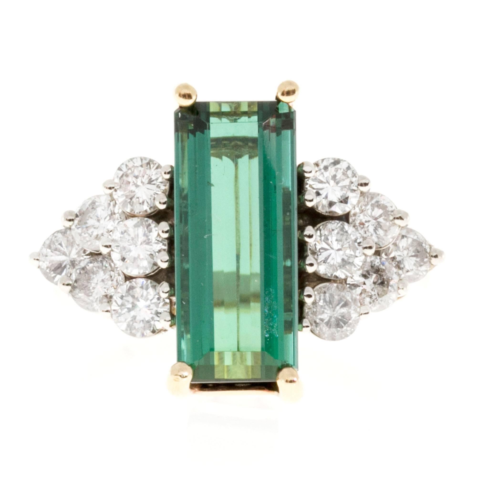 Elongated emerald cut deep green Tourmaline in a handmade 14k yellow and white gold setting. From the Peter Suchy workshop. 

1 emerald cut green Tourmaline approx. total weight 4.30cts
12 round diamonds approx. total weight 1.20cts, H, SI1
14k