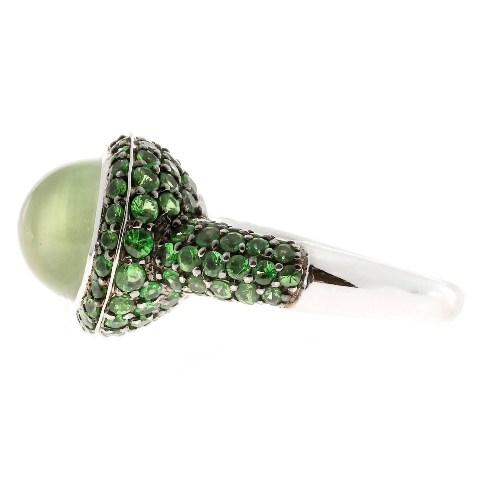 Crivelli 18k white gold designer cocktail ring with bright green Tsavorite Garnets and a high dome Peridot cabochon. 

Approx. 127 Tsavorite Garnets approx. total weight 2.40cts
Genuine light Peridot cabochon 10mm wide, approx. total weight