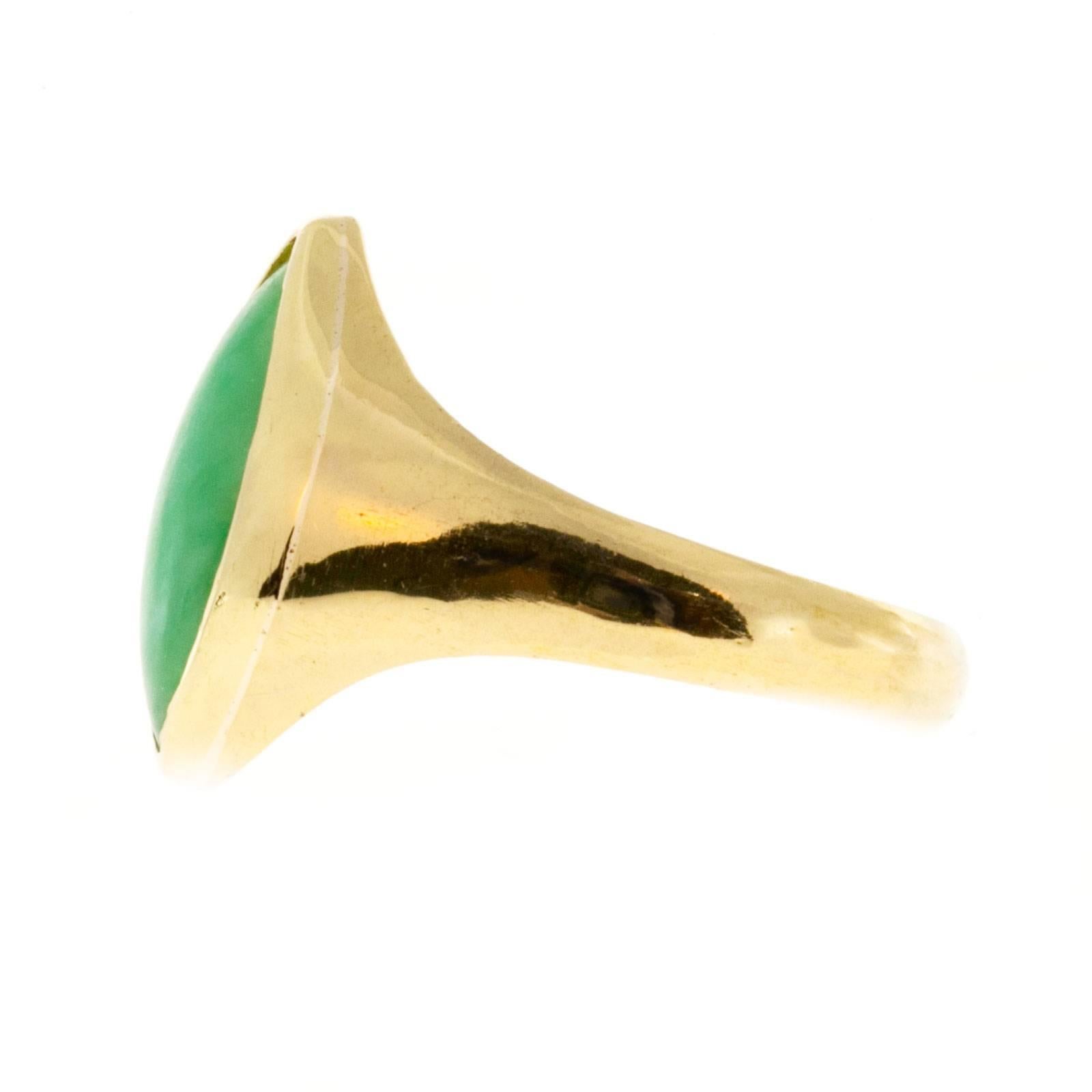 A grade natural color Jadeite Jade in a yellow gold gold ring. The stone was recently polished and the GIA certificate shows this. The color is all natural.

Translucent 13.50 x 6.40 x 2.50mm Marquise GIA certificate # 2145296415, GIA certified