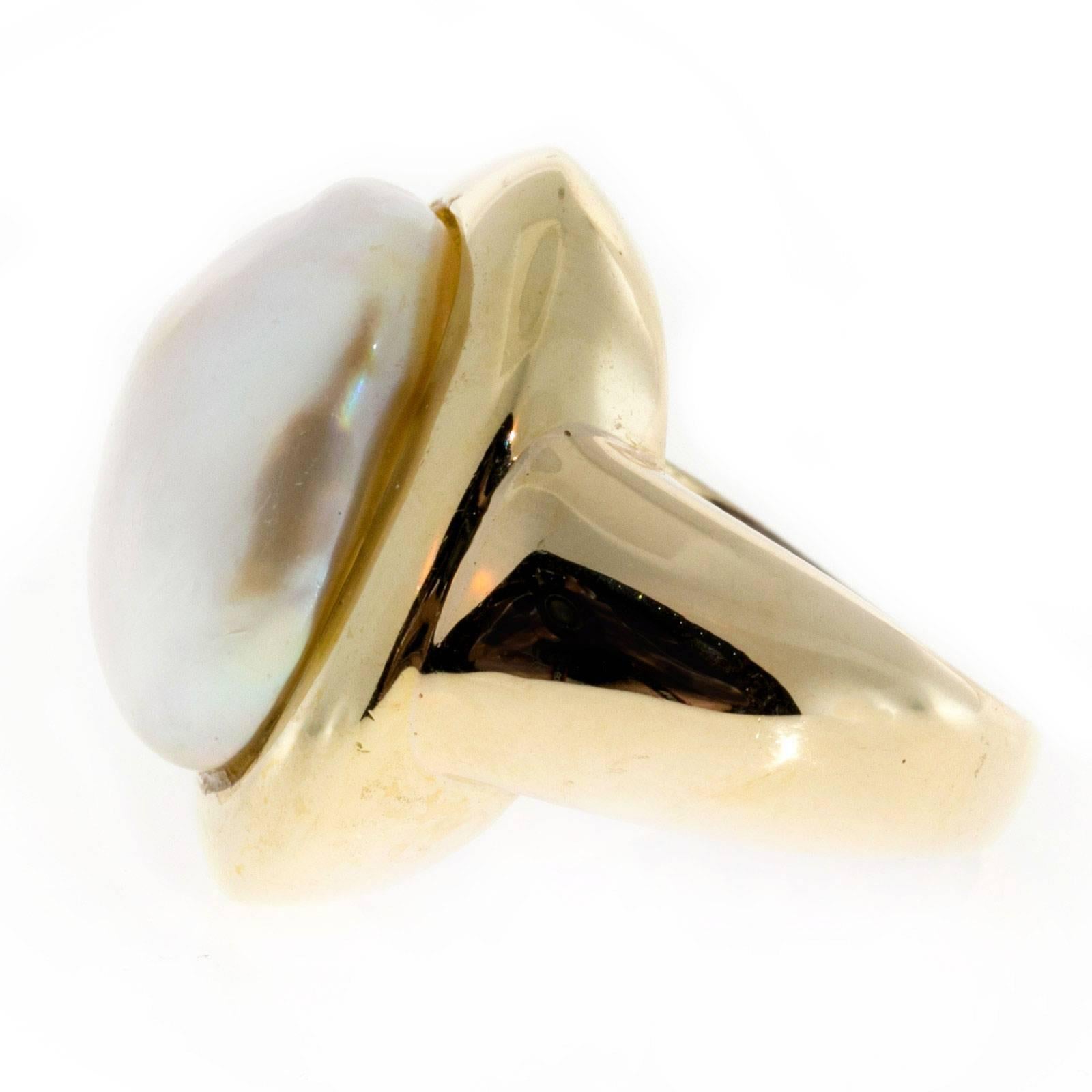 Vintage wonderful extra-large south sea cultured pearl ring in a simple solid yellow gold substantial ring artistically filled securely around the pearl. Circa 1950-1960.

1 South Sea 21 x 16.9 x 12.9mm cultured white pearl yellow gold ring.