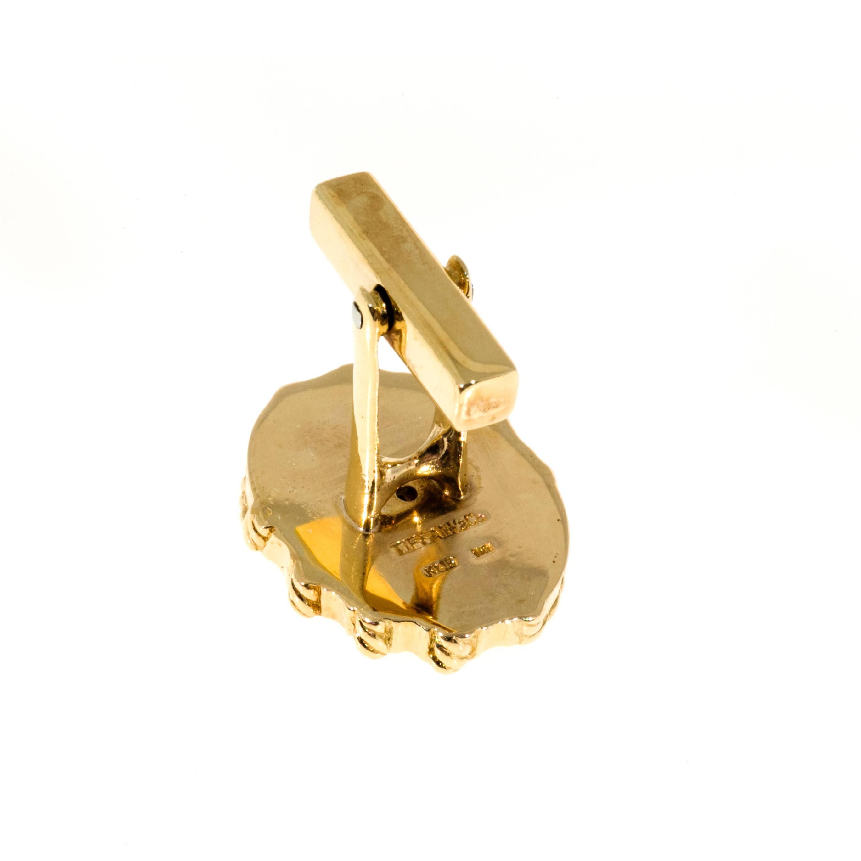 Tiffany & Co 18k yellow gold clip back cuff links with twisted wire detail.

Oval top 21.56 x 17 x 3.85mm or .83 x .68 x .15 inches
18k Yellow Gold
Stamped: Tiffany + Co K 18 Italy
20.8 grams