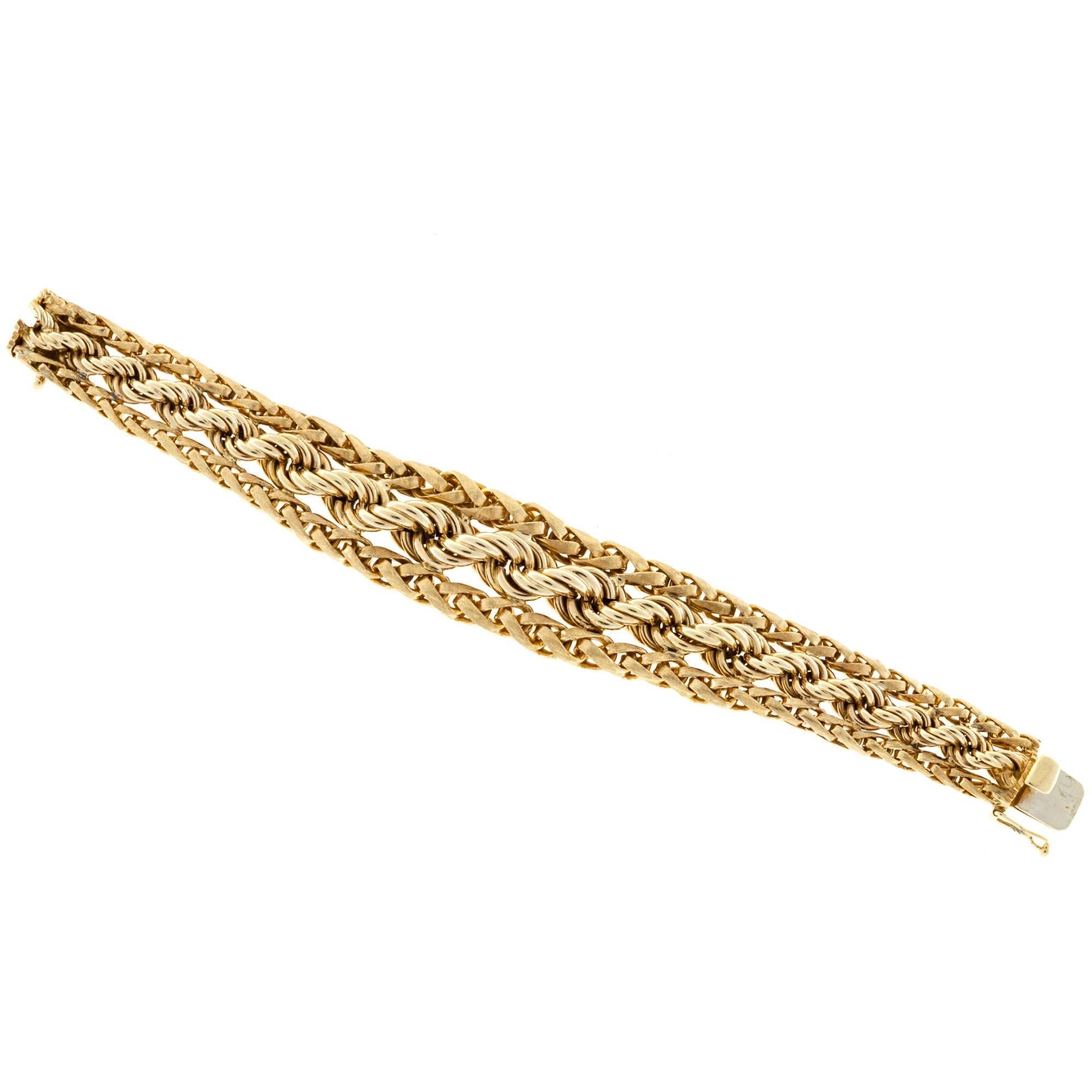 1955 Hand Florentine wheat chain on each side of a graduated rope chain bracelet. 

14k Yellow Gold
Stamped: 14k
83.5 grams
Length: 7 3/8 inches
Width: ½ to 7/8 inch