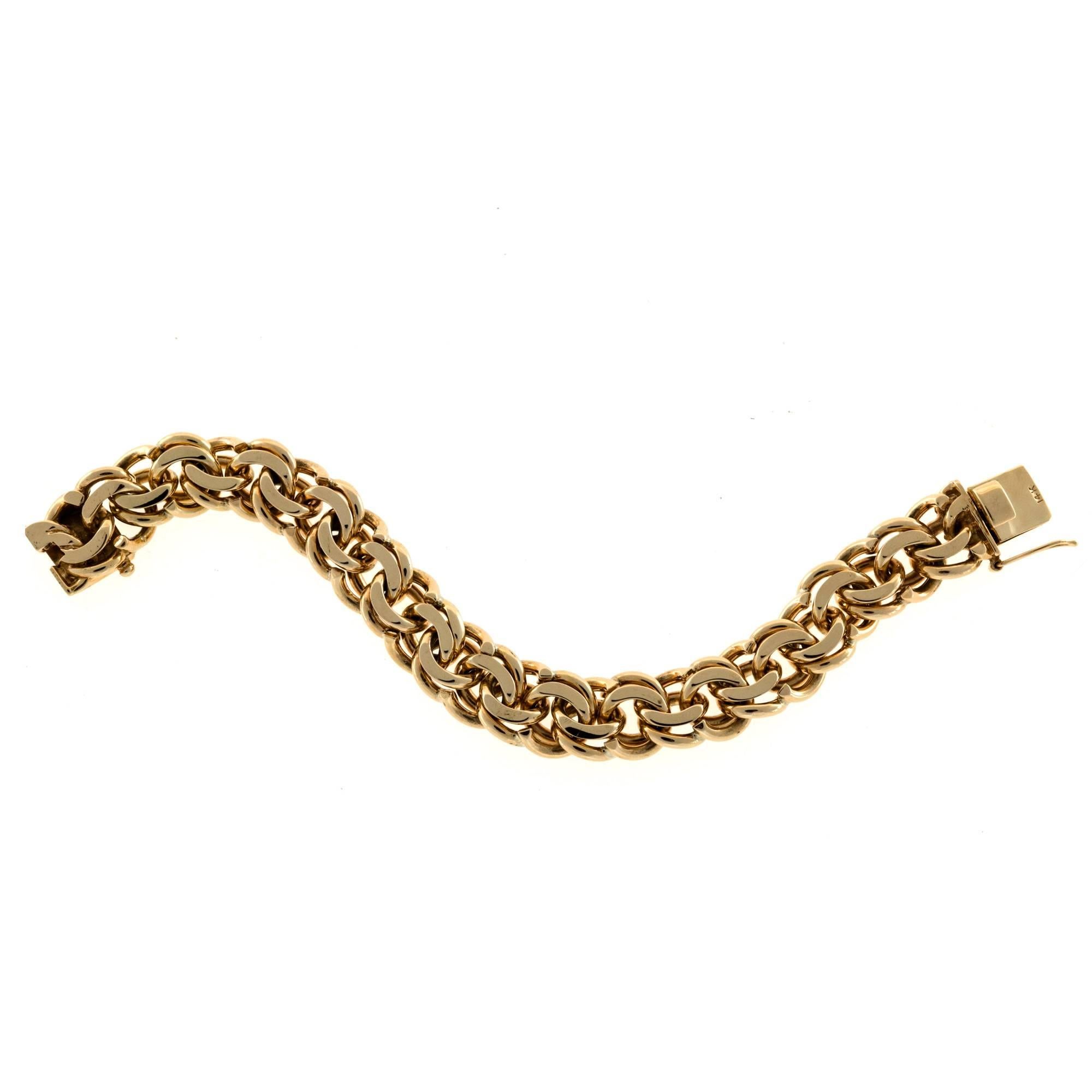 Extra heavy solid 14mm wide handmade double spiral link charm bracelet. Can be worn alone or will hold extra heavy charms. Circa 1940.

14k yellow gold
Tested and stamped: 14k
78.20 grams
Length: 7.25 inches
Width: 14.04mm
Depth: 6.37mm