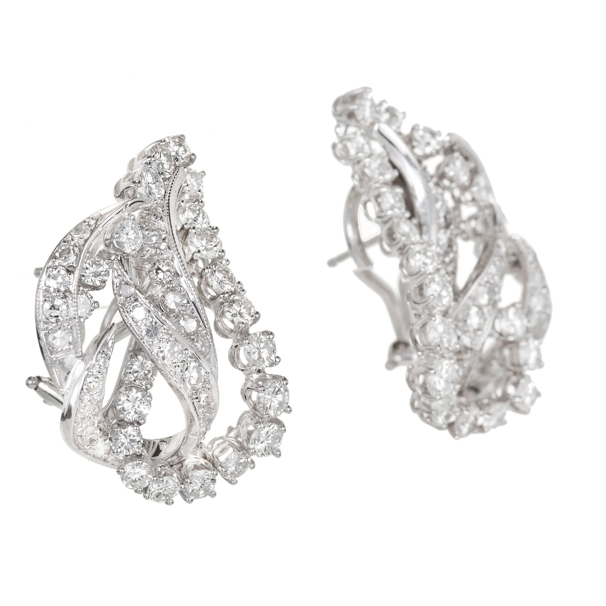 1950’s handmade 2 dimensional classic swirl clip post earrings with full cut and single cut diamonds. Super bright white and sparkly. 

44 full cut diamonds, approx. total weight 2.25cts, F, VS
46 single transitional cut diamonds, approx. total