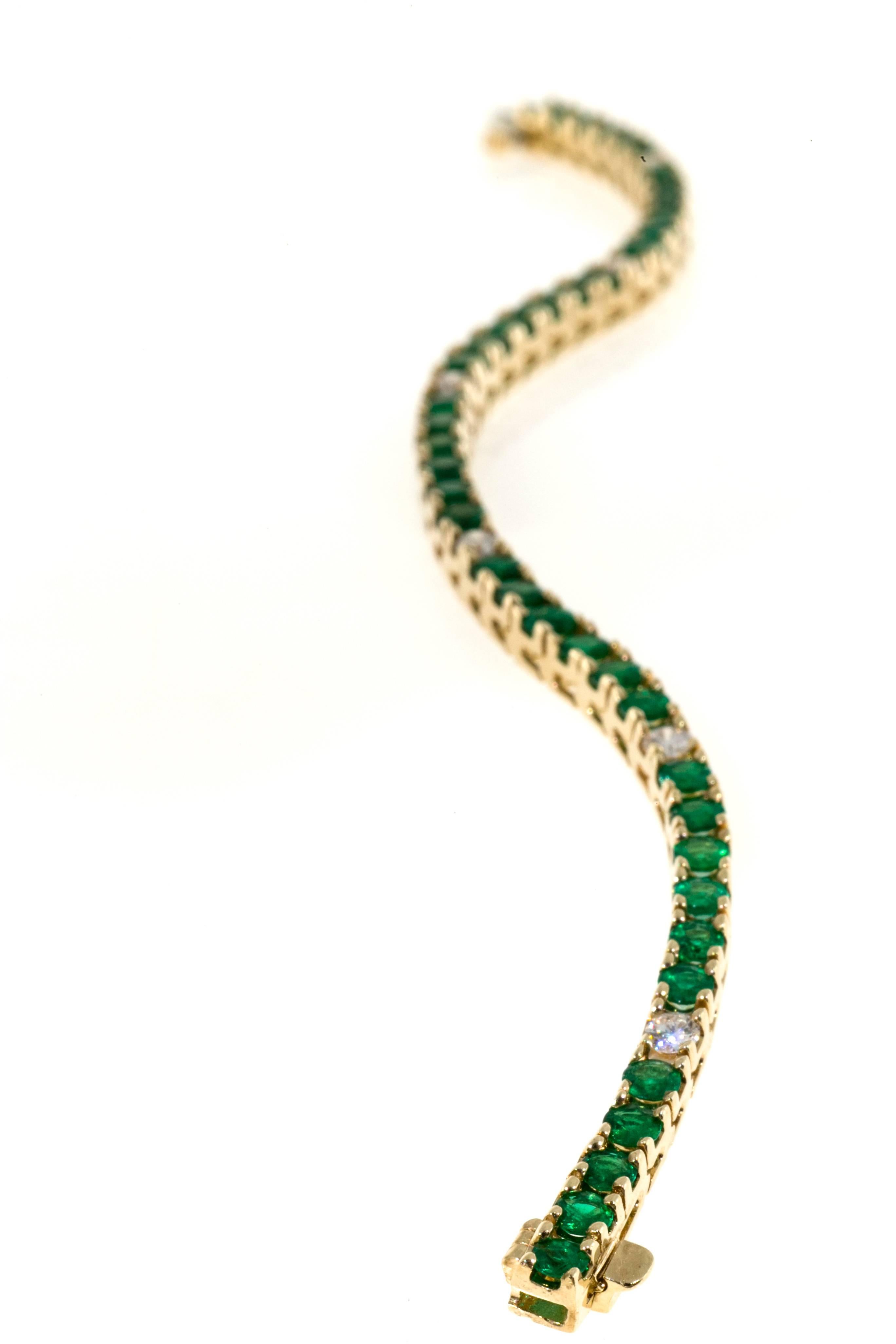 Green Emeralds and full cut diamonds in a 14k yellow gold hinged link bracelet with built in catch and underside safety.

6 round brilliant cut diamonds, approx. total weight .67cts, H, SI1
40 3.2mm natural bright green Emeralds, approx. total