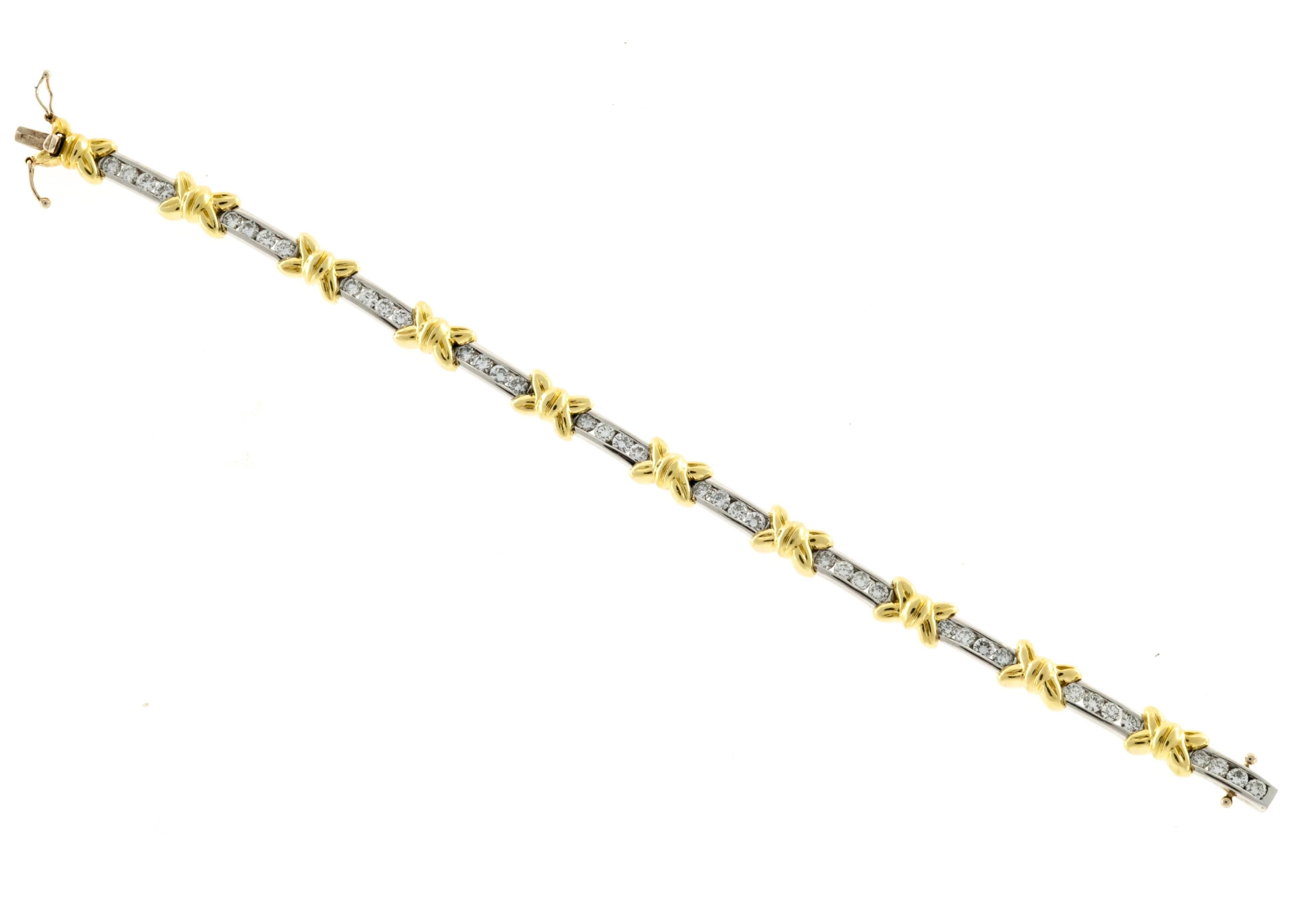 Diamond Platinum and 18k yellow gold bracelet. Signed CRO. Platinum channels separated by 18k “X” style bows. Hidden catch with double safeties. 

Platinum
40 round diamonds 4.00ct total weight. F, VS
18K Yellow Gold
Stamped: CRO 18k