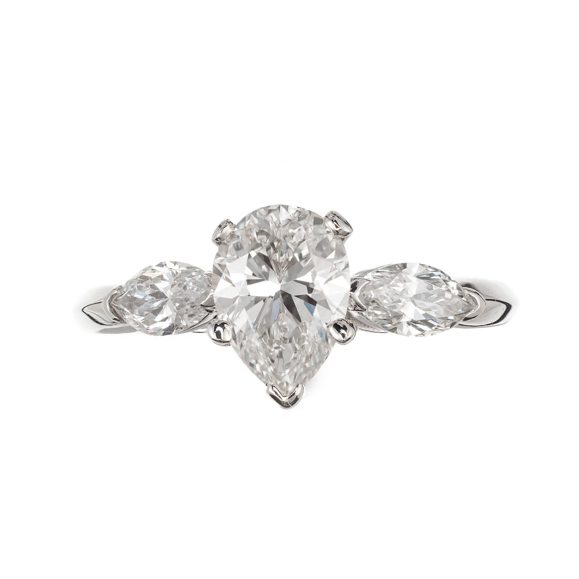 Pear shape diamond three-stone engagement ring. 14k white gold setting with tow bright white Marquise diamonds on each side of  pear shaped diamond center. Circa 1950-1959. 

1.25ct, pear brilliant cut 8.40 x 6.40 x 4.02mm K, SI1
2 Marquise cut