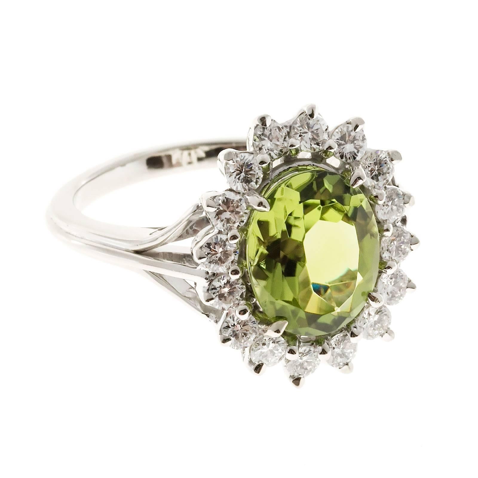Bright extra sparkly genuine natural untreated Peridot ring from an estate surrounded by bright shiny full cut diamonds. Circa 1960 -1970.

1 oval bright medium green Peridot, approx. total weight 3.00cts, VS, 10.62 x 8.67 x 4.09mm
16 round