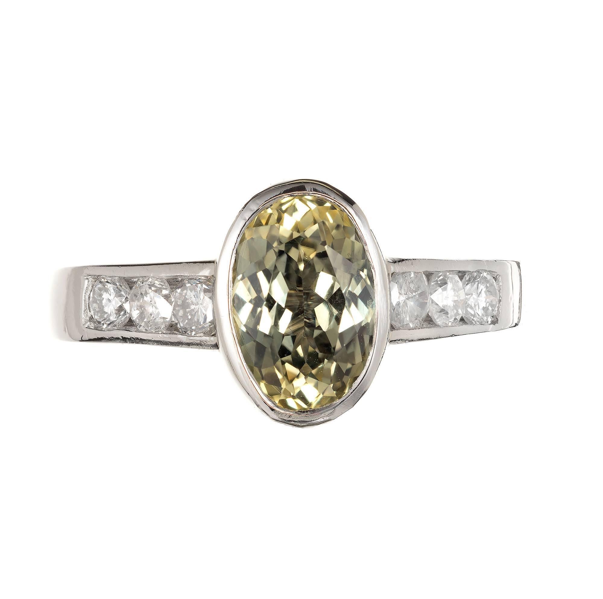 Oval 2.20 carat green yellow sapphire engagement ring. Fancy color natural no heat, no enhancement.  Handmade Platinum setting accented with round diamonds.  Color and tone change in different light. 

2.20ct natural no heat fancy greenish yellow