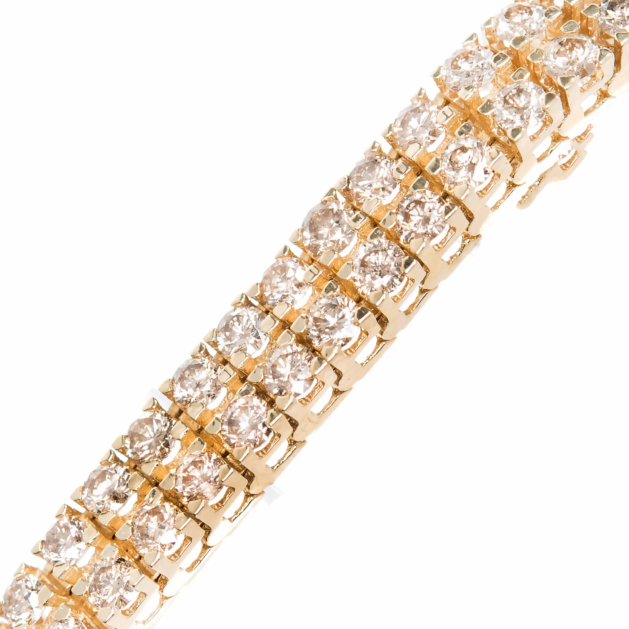 1980's Two row light brown, yellow diamond 14k yellow gold bracelet. 114 round cut diamonds totaling 8.00cts  White gold tongue on catch. Built in catch and side lock safety. 6.8 inches in length.

114 natural fancy golden yellow diamonds approx.