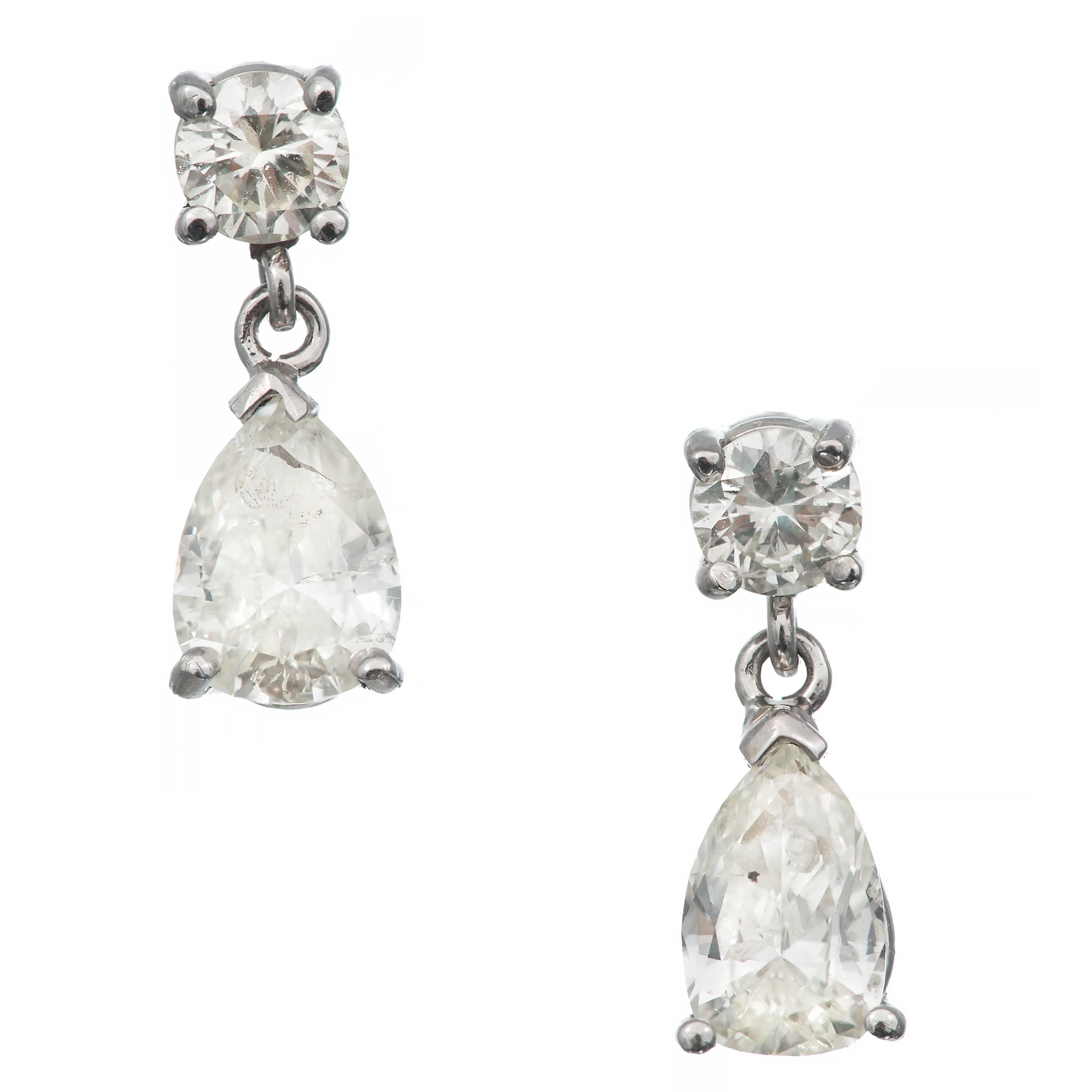 Mid-century 14k white gold dangle earrings with round full cut diamond tops and pear shaped diamond dangles. Circa 1960.

2 round diamonds, approx. total weight .39cts, H-I, SI1
2 pear diamonds, approx. total weight 1.10cts, H-I, SI2 – I1
14k white