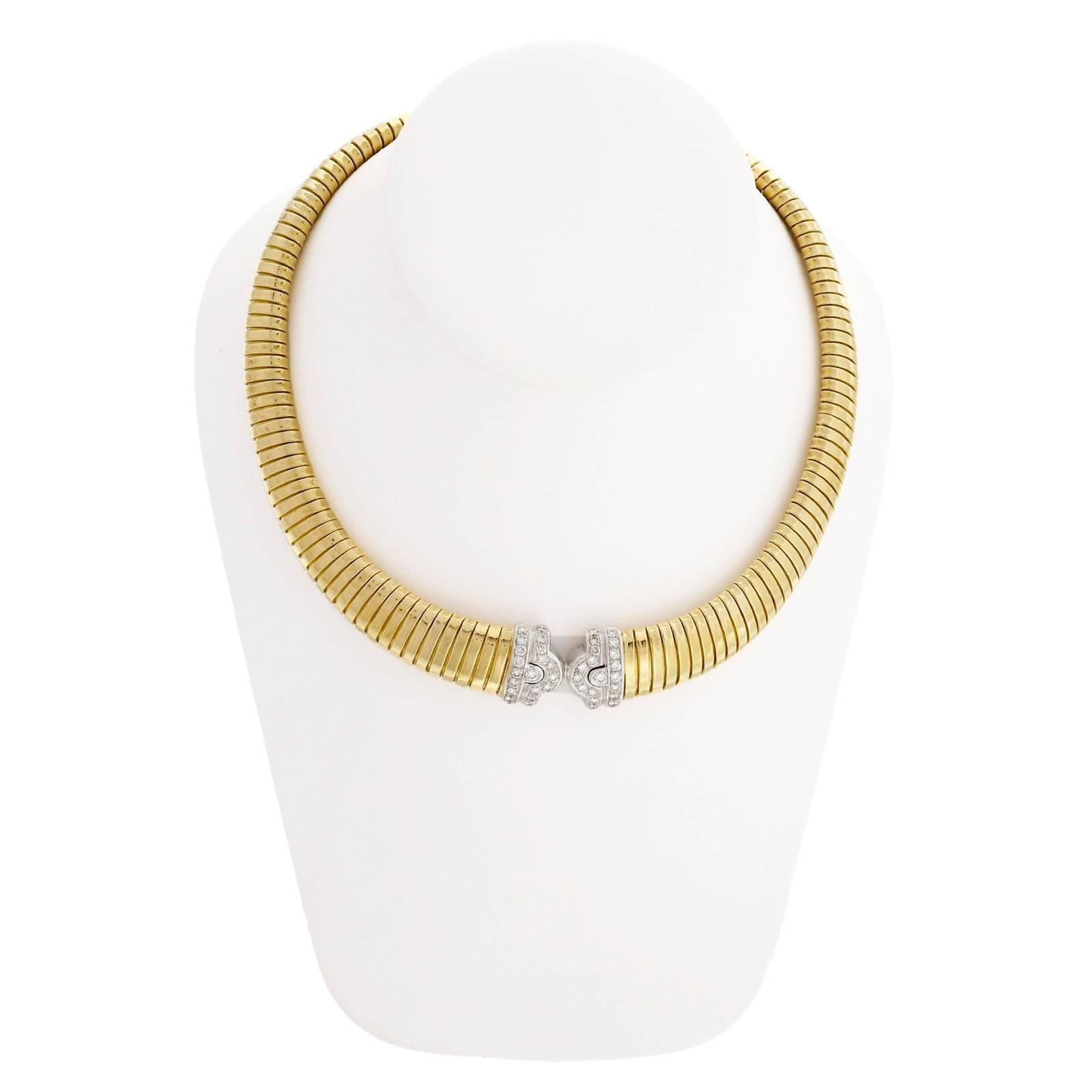 Vintage 1970-1980 solid 18k gold Tubogas necklace with white gold center section. Nice 17 inch length. One small dent on the back to the left of the diamond section. No dents or other marks on the front.

38 round diamonds, approx. total weight