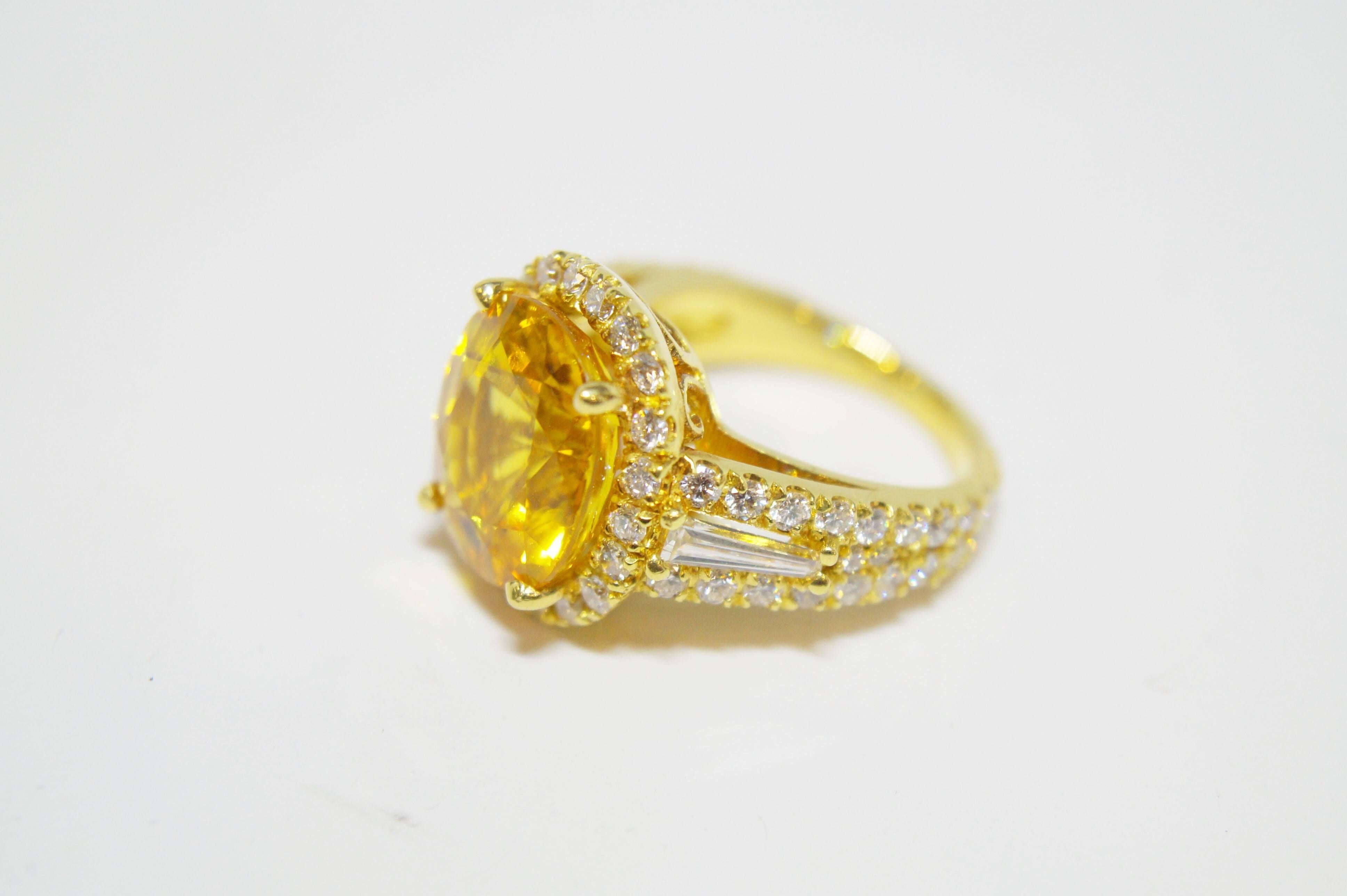 This beautiful ring showcases an exceptionally richly colored yellow sapphire weighing 10.82 cts. The ring also contains 68 full cut, 1.73 cts total weight approximately, G color, VS2 clarity, round diamonds in a halo design and tapering down the