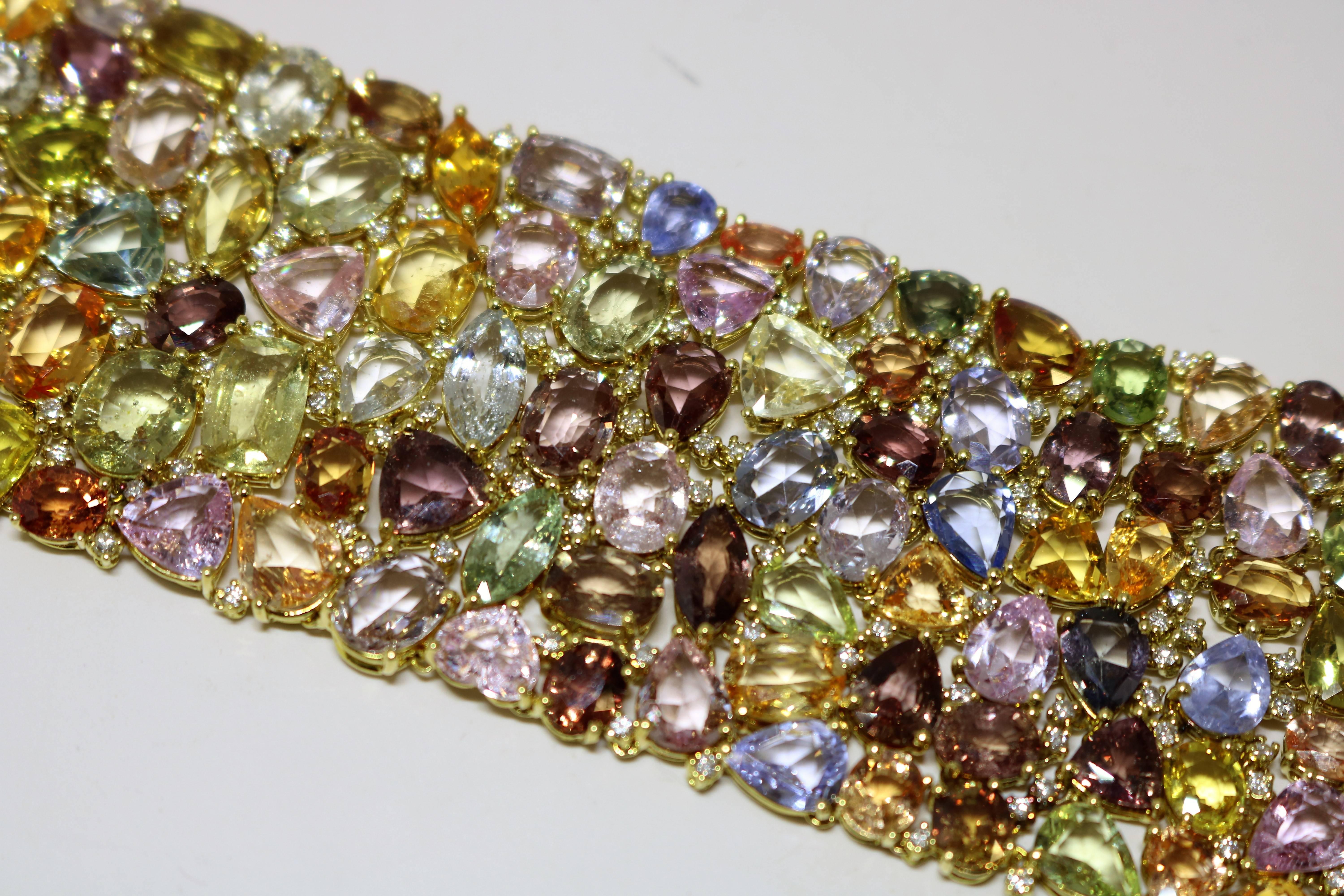 This 18k Yellow Gold Handmade mounting; 225.39 ct multicolor sapphire. genuine and 2.18 ct diamond interspersed throughout. Bracelet is 1 3/4 in width made beautifully flexible for total comfort