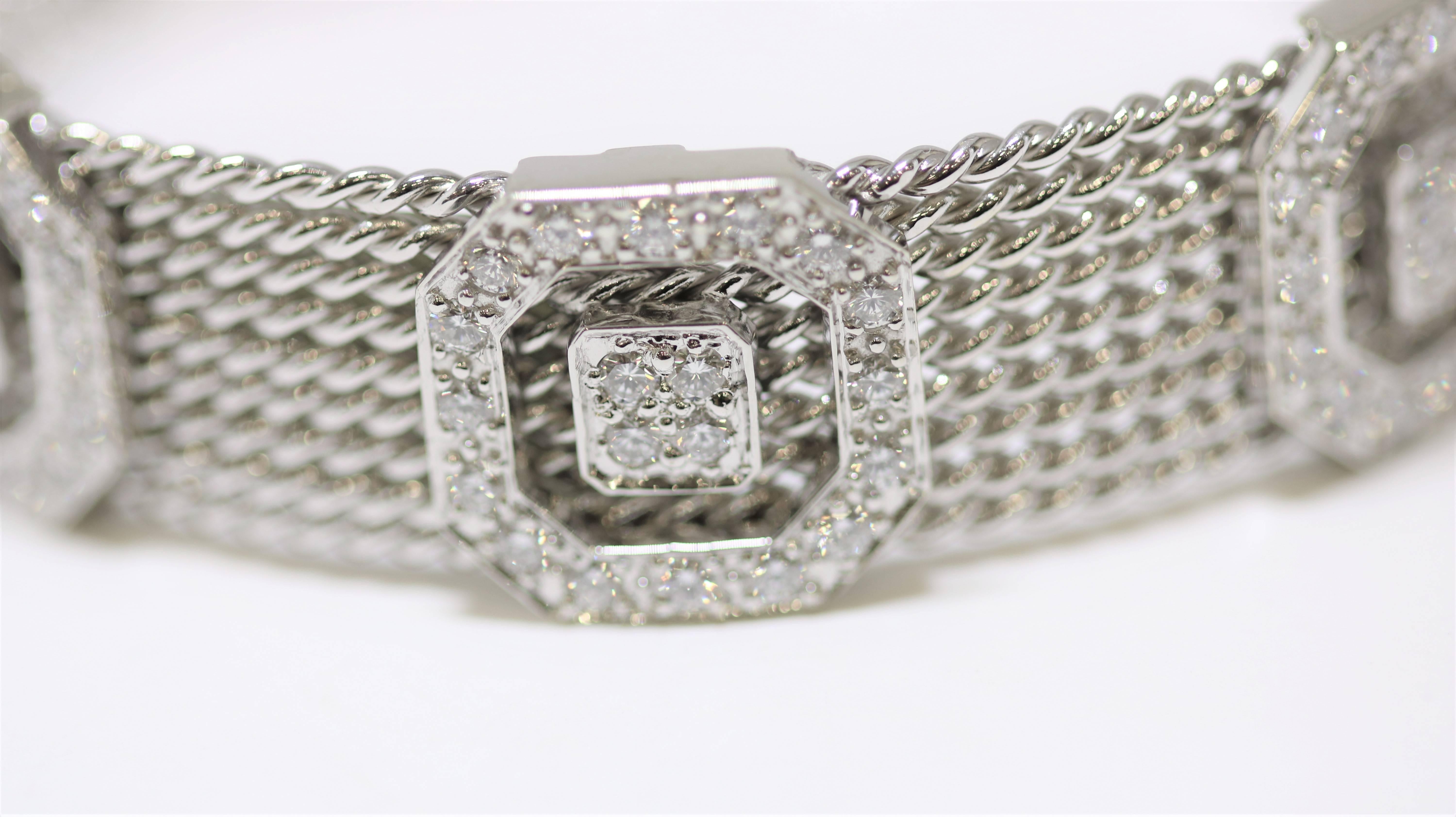 This multi strand bangle is made of14k white gold with 3 square diamond sections; slightly flexible; 60 diamonds weighing 2.85 ct total weight.

