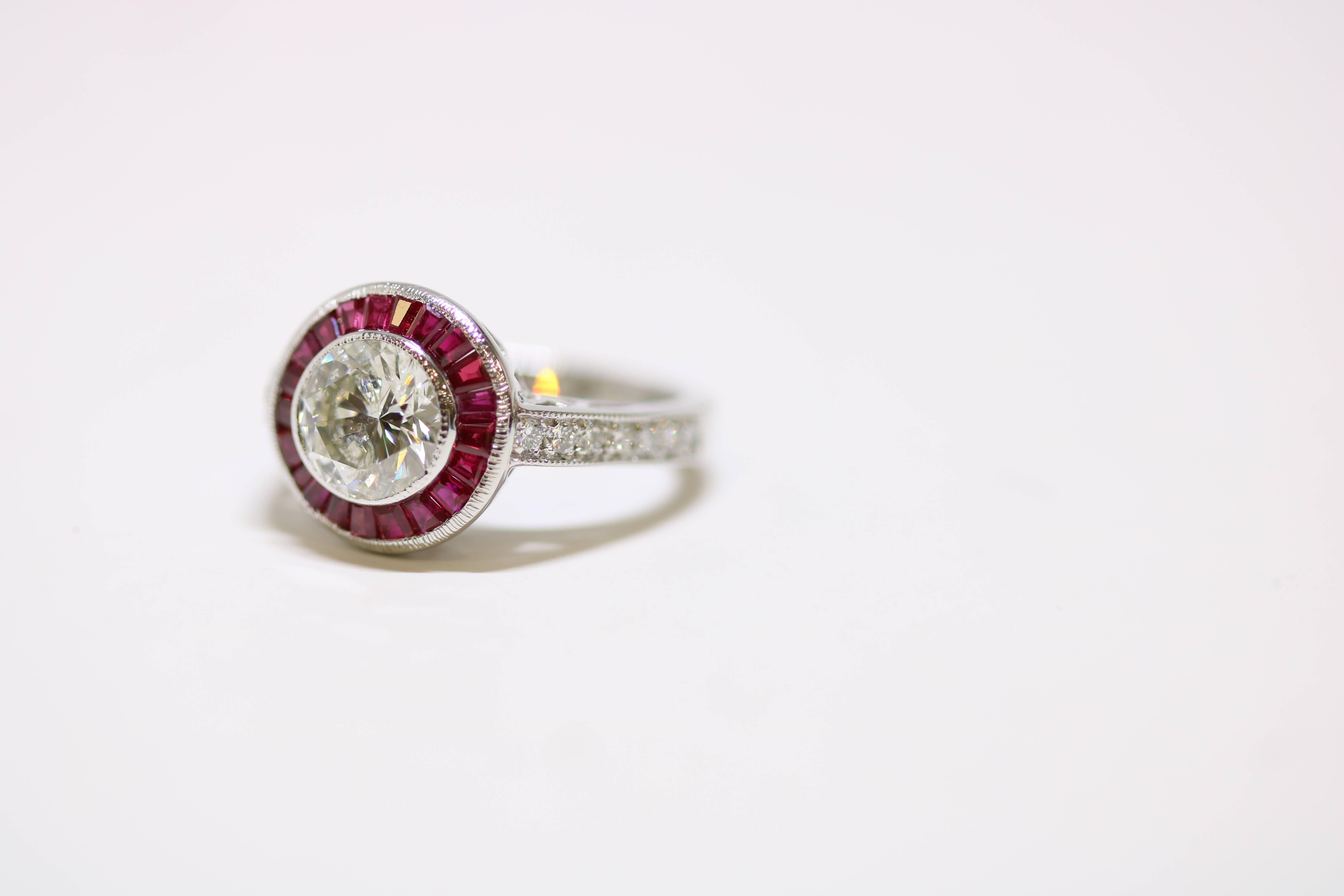 This antique style platinum, round and tapering ruby ring contains; 2.10 cts  center diamond, bezel set; channel set gem color rubies, baguettes and tapering .87 cts, total weight, .47 cts, 14 diamonds,  fine white, VS2 clarity 
