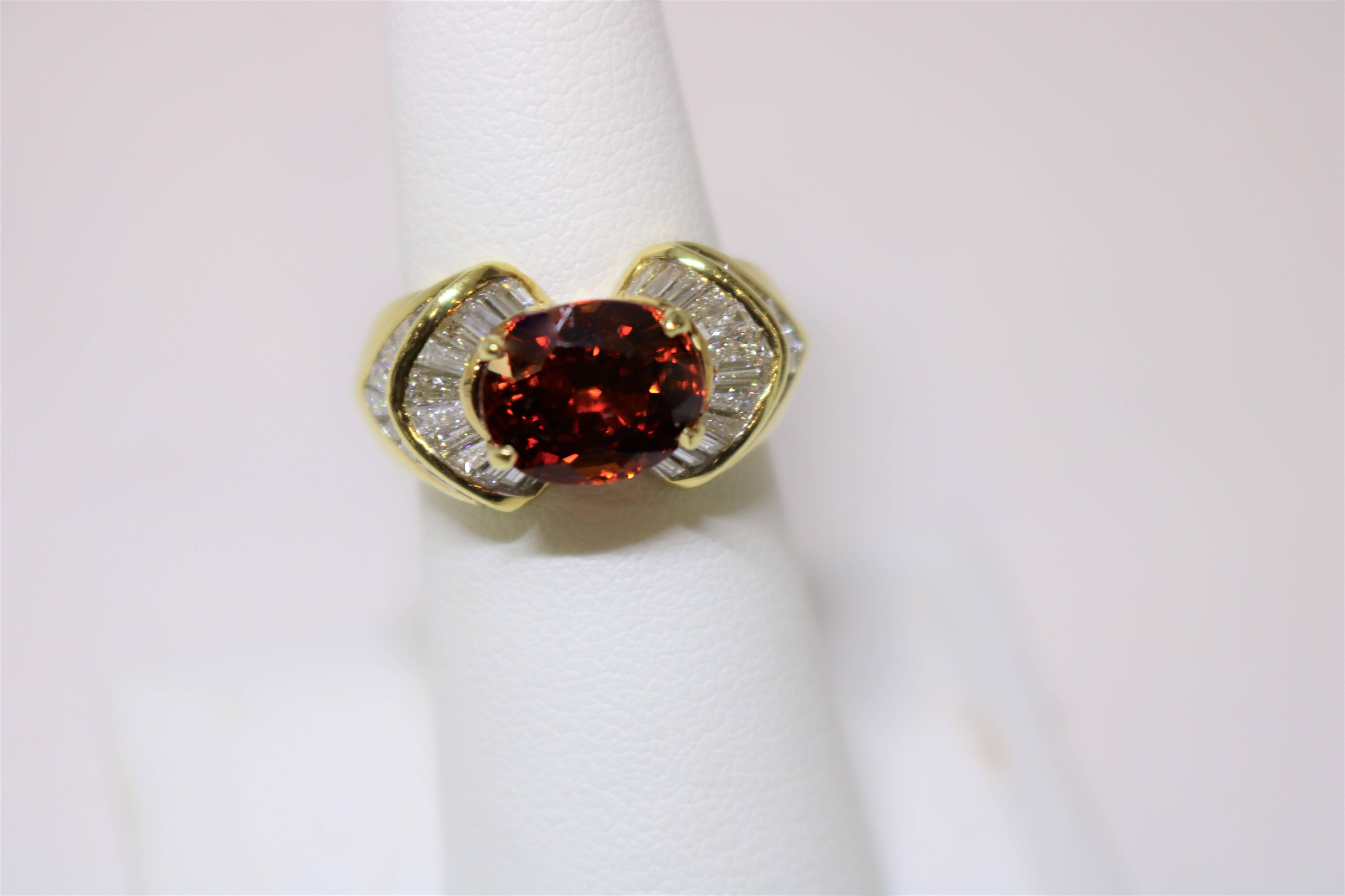 This exquisite evening ring is set in 18k Yellow Gold with 1.68 ct Diamonds surrounding the Spessartine Garnet weighing 4.85 cts. 
