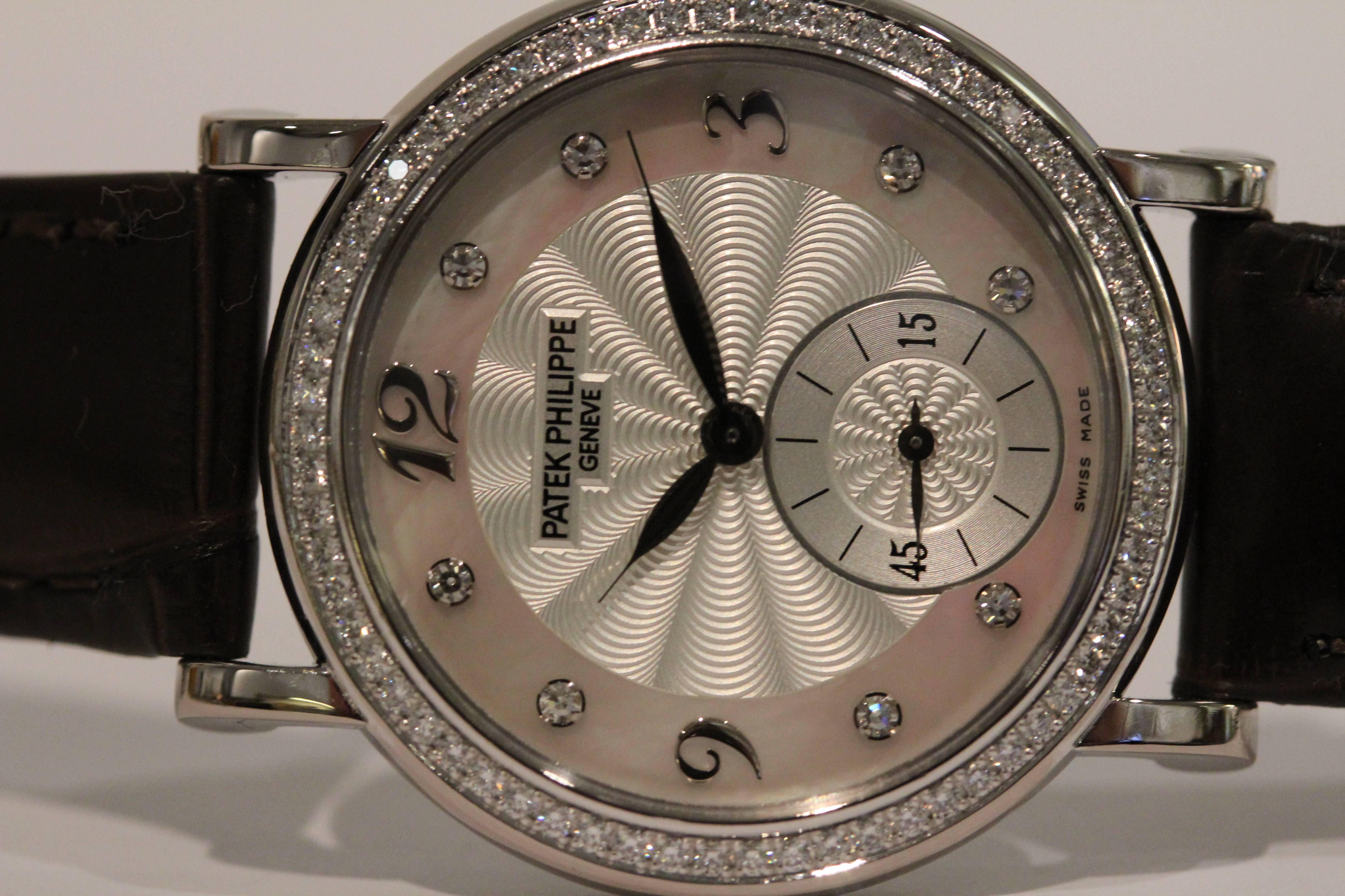 18 karat white gold Patek Philippe with a mother of pearl dial. Diamond hour markers and bezel. 4959G