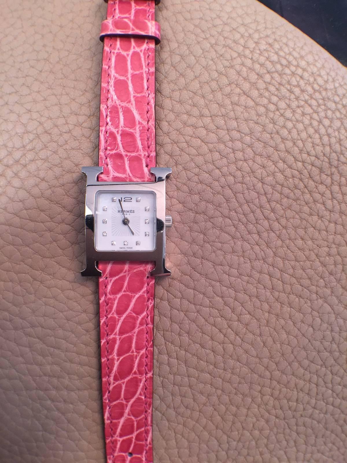Ladies stainless steel Hermes H-Our watch with white mother of pearl dial. 11 diamond markers. Alligator strap.
