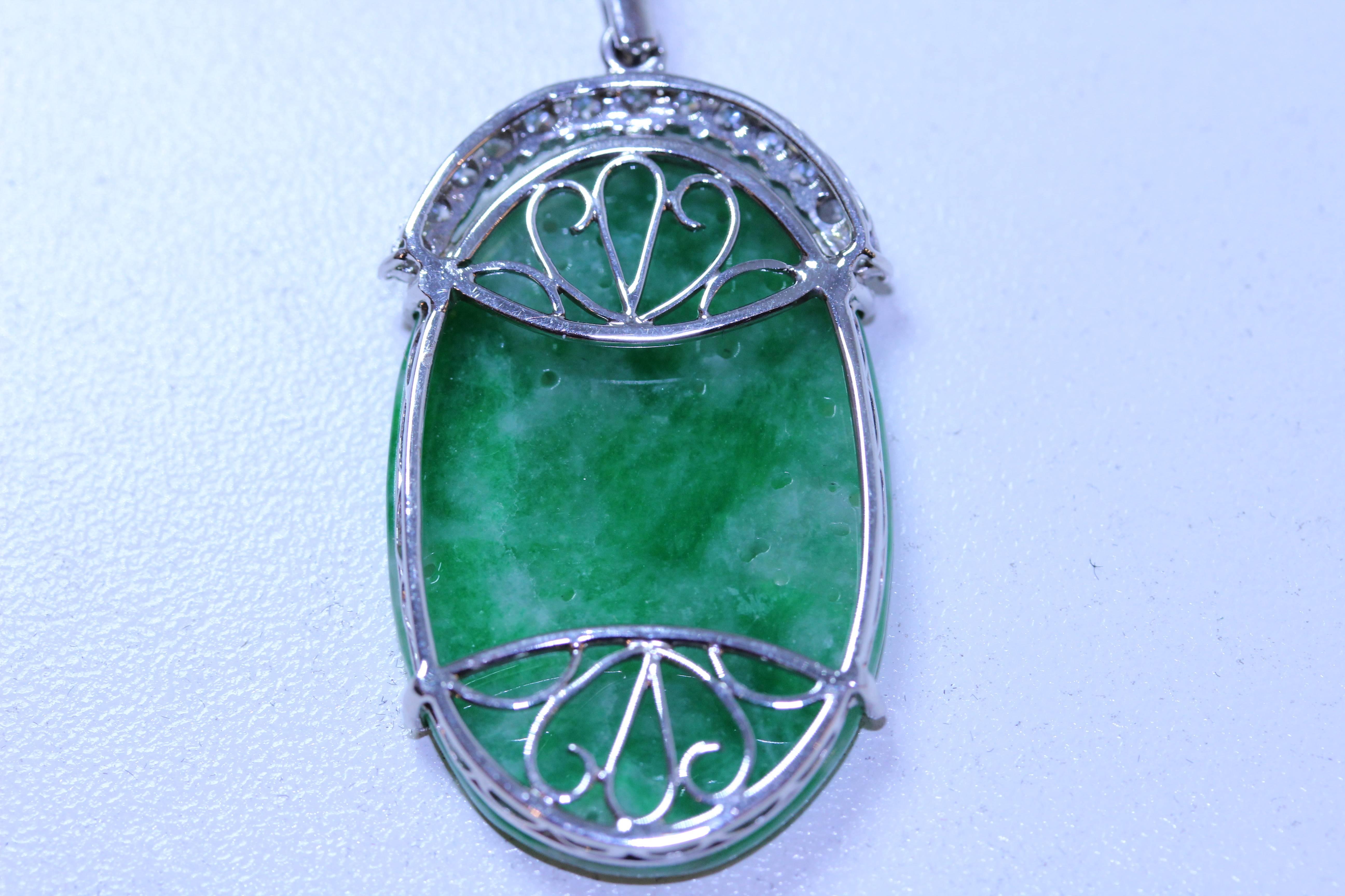 18 karat white gold carved pierced jadeite butterfly, lotus flower with diamonds. Diamonds equal .70 total weight. 16 inch diamonds by the yard chain. 9 diamonds equal .05 total weight. I-J in color. GIA report.