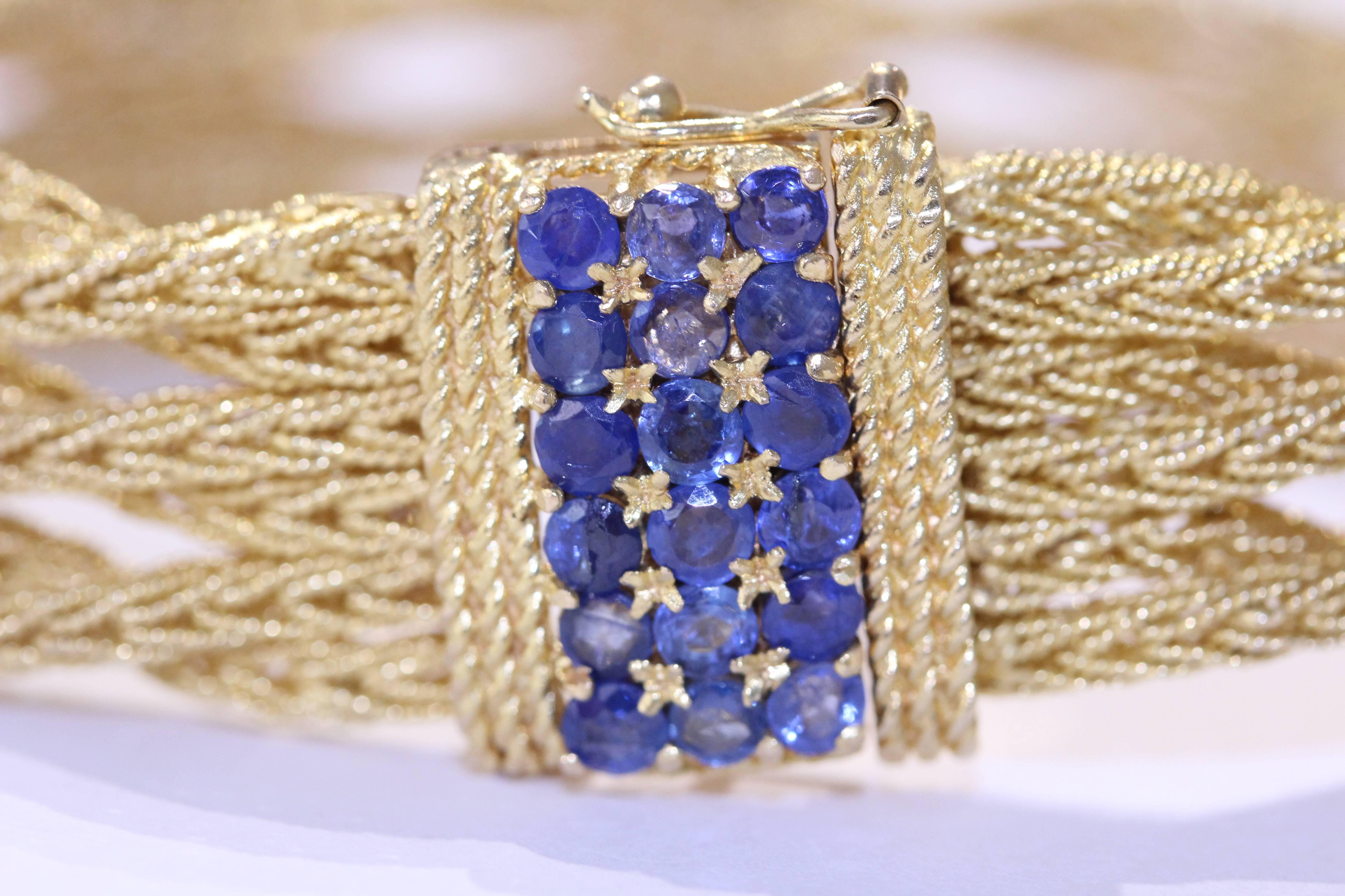 18 Karat yellow gold sapphire Cartier 6 row interwoven bracelet. The bracelet
has a box clasp with triple rope edge design. 18 round
blue sapphires set in a prong setting.Approximately 1.65ct. Circa 1970s 55grms