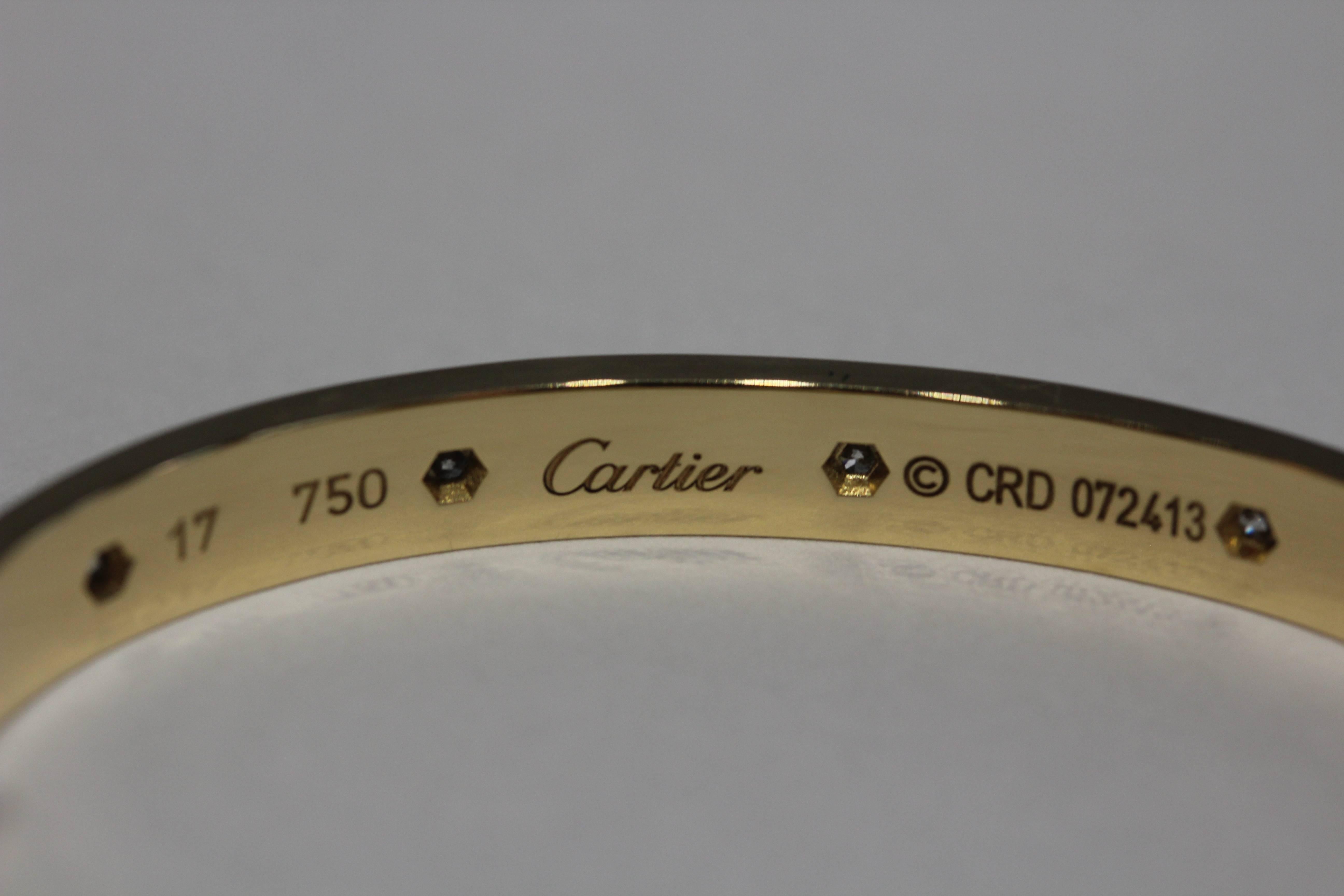 18 Karat yellow gold Cartier Love bracelet with 10 round diamonds wrapping around. The diamonds weigh about .96 total carat weight. The bracelet size is 17. The Screwdriver is included with box and papers. Serial number #CRD072413