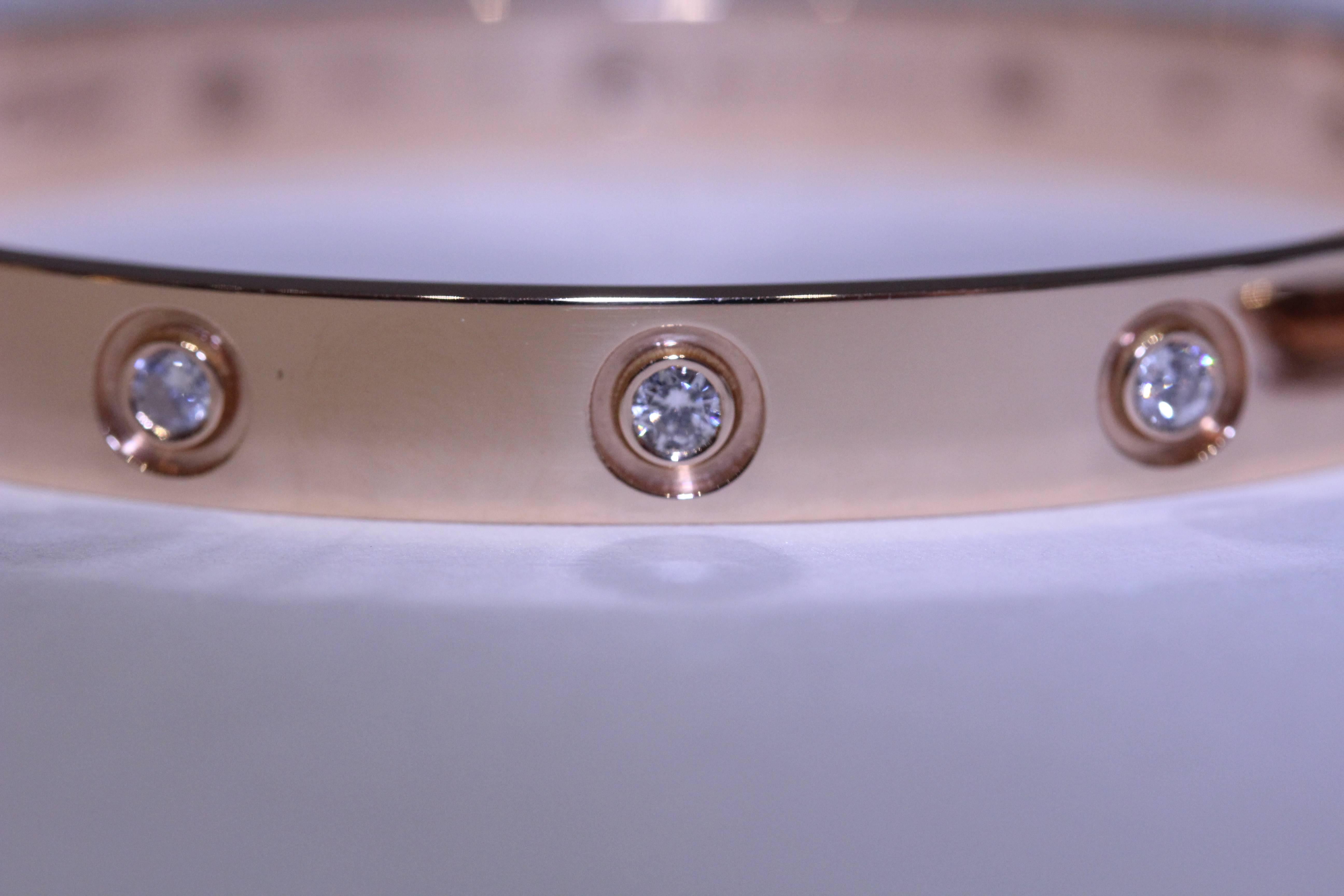 18 Karat rose gold Cartier diamond Love bracelet with 10 round diamonds. The
10 round diamonds weigh .98 total carat weight. The serial number is QP4121J2. The bracelet comes with its original box, papers and screwdriver. Size 17
