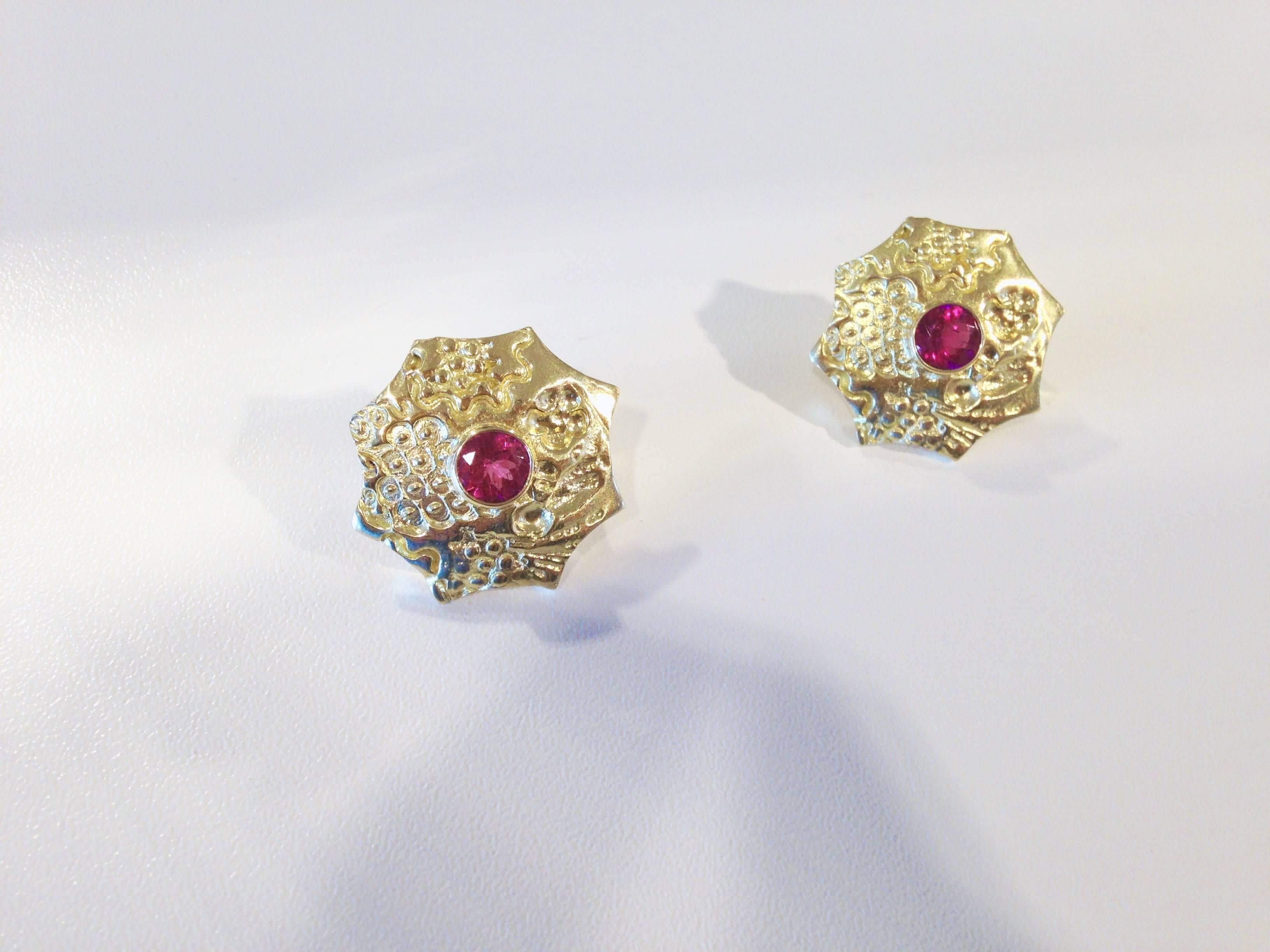 These Susan Lister Locke earrings are made with 1.60ct Red Tourmalines set in her original 18k Gold Sea Urchin design. The variety of the raised textures adds an elegance to the already striking color of the tourmalines. Omega clasps secure these