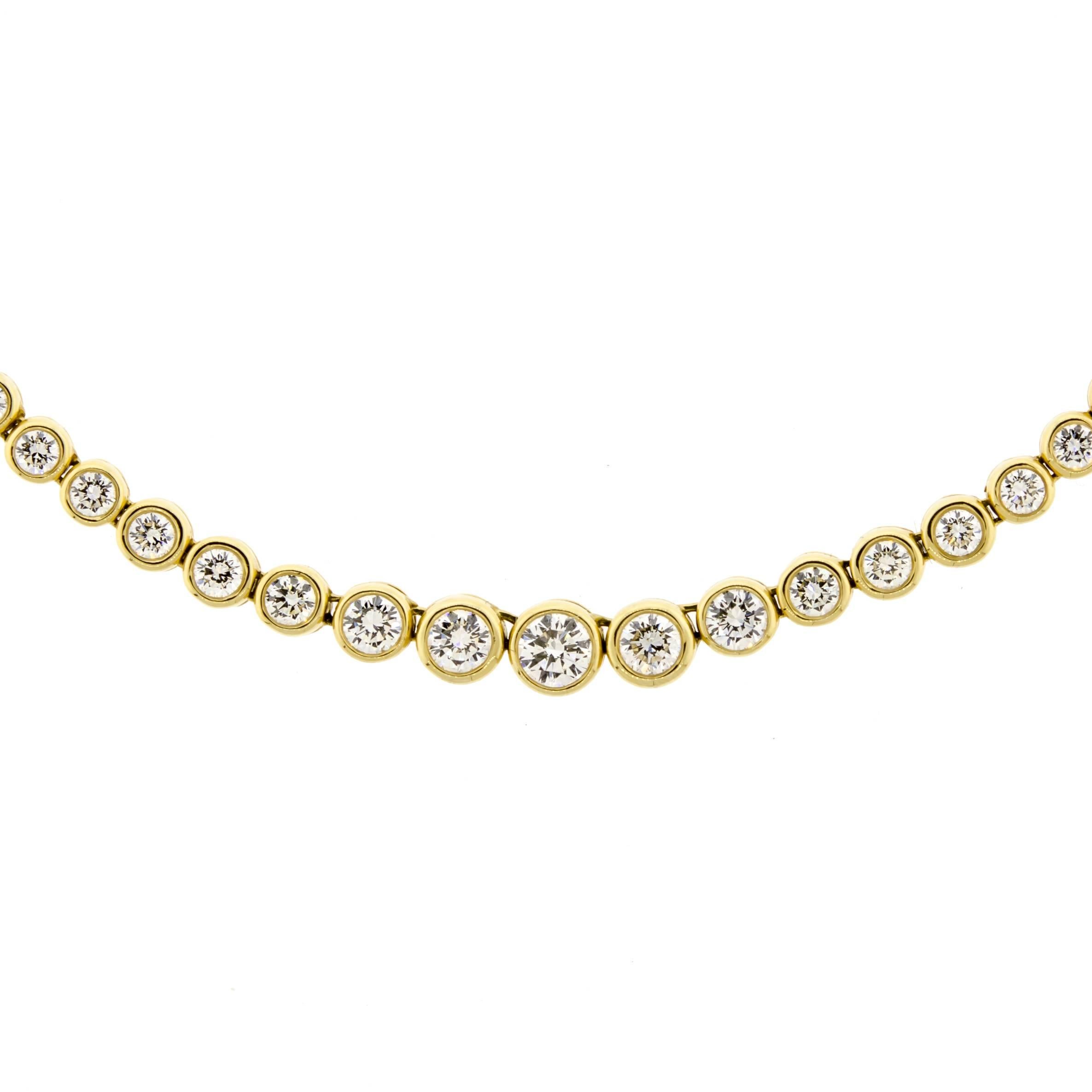 This stunning contemporary diamond and 14kt yellow gold lady's tennis style necklace sparkles and dazzles magnificently. The ravishing Round Brilliant Cut diamonds pop against the high polished glowing 14 karat yellow gold in which they are set.  
