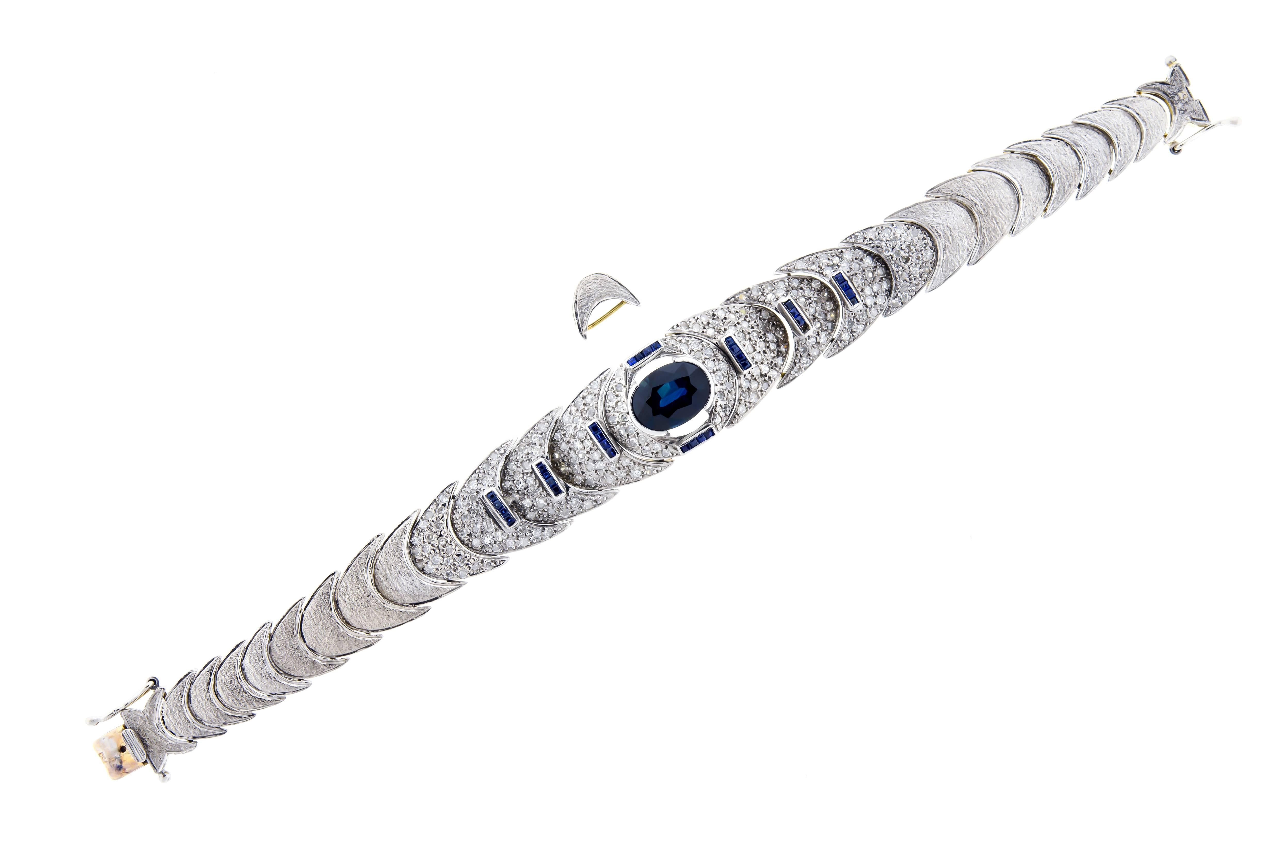 Beautiful lady's 1970s blue sapphire diamond and 18kt white and yellow gold flexible bracelet cast and hand assembled half moon link bracelet with v spring closure with two safety clasps and a textured finish.  Bracelet is 6.5 inches long with an