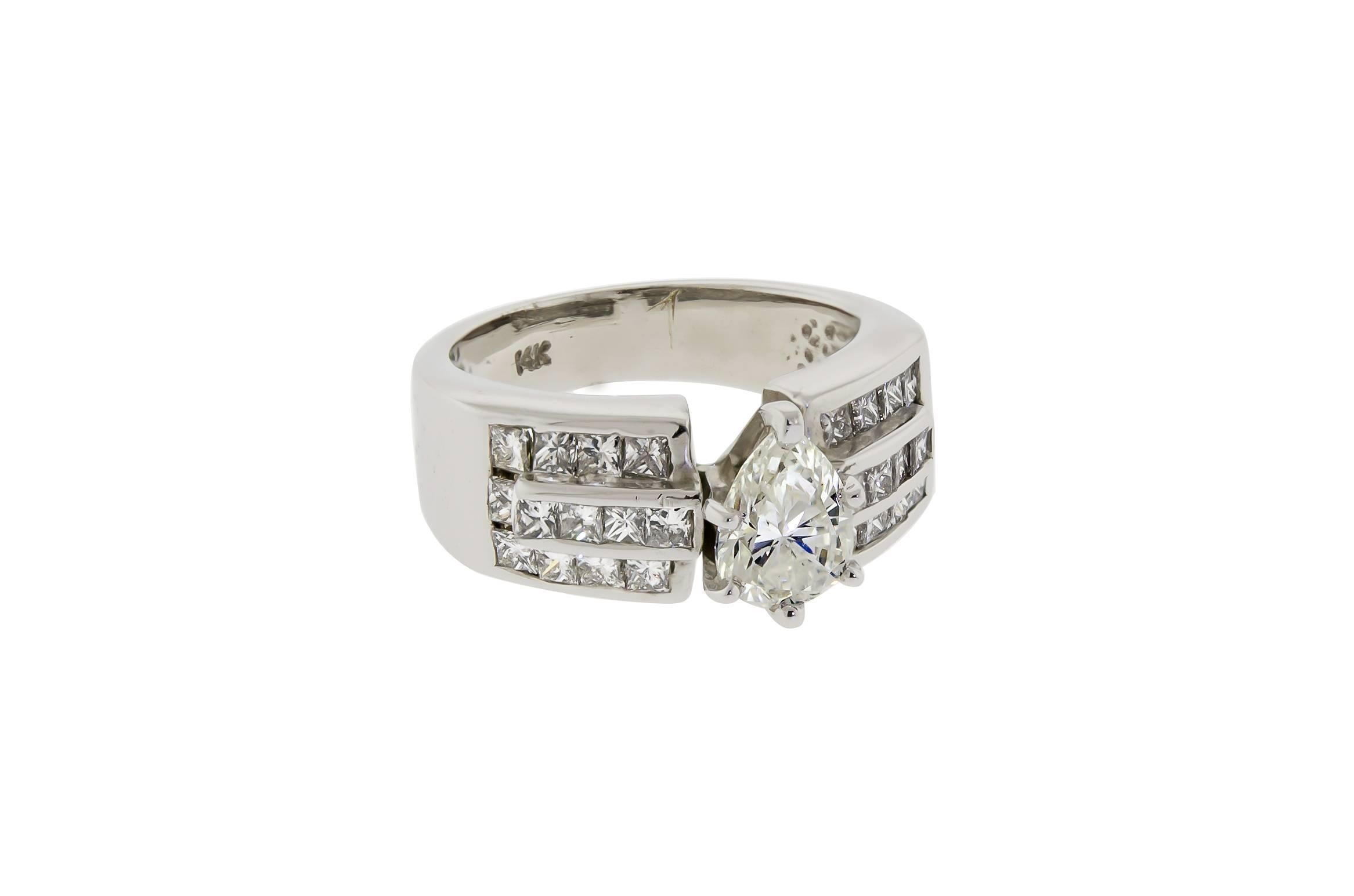 Contemporary lady's 14 karat white gold and diamond engagement ring containing one prong set pear shaped faceted diamond measuring approximately 1.00 ct, Clarity SI-1-2, Color I, Cut Good, accented with twenty-six channel set princess cut diamonds,