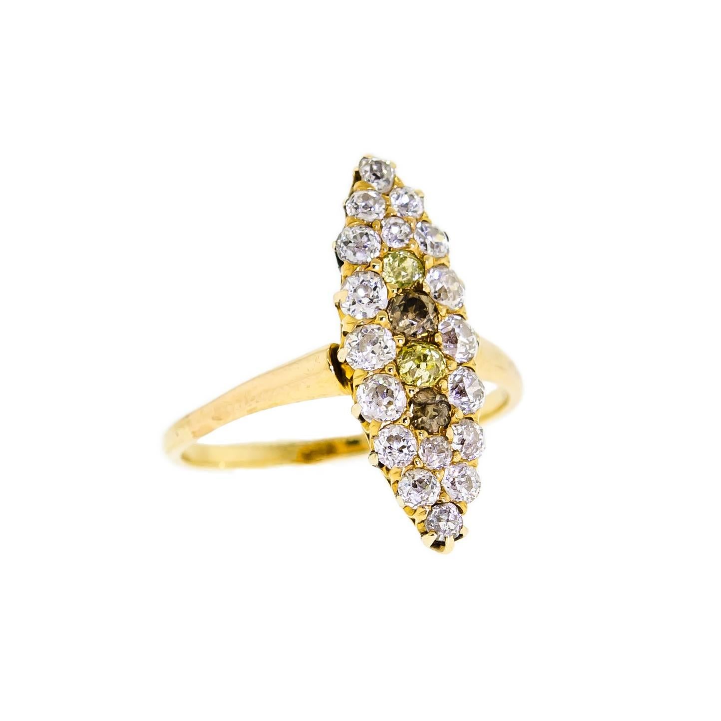 This sweet antique turn-of-the-Century yellow gold and diamond ring, within a navette shaped setting, is set with two stunning Old Mine Cut yellow diamonds weighing approximately 0.12cts total and 18 dazzling Old European Cut and Old Mine Cut