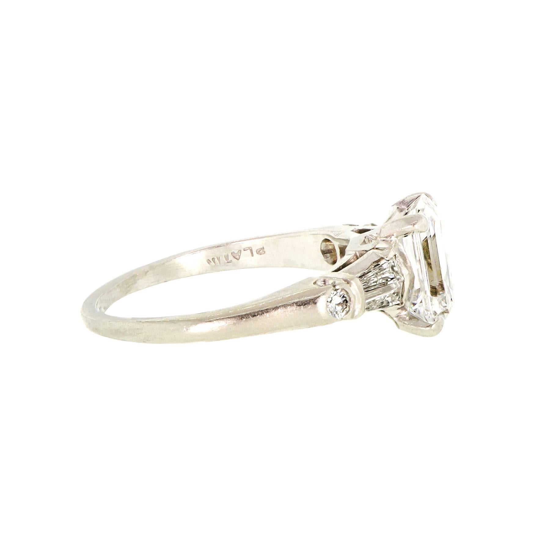 Vintage 1.84 ct. emerald cut diamond ring VVS2 - F plus .23 cts. two tapered baguettes. channel set .17 cts approx. total weight along with two round .06 cts. total weight   diamonds all set in a platinum mount.  

Appraisal provided.

8.20 x 5.95 x