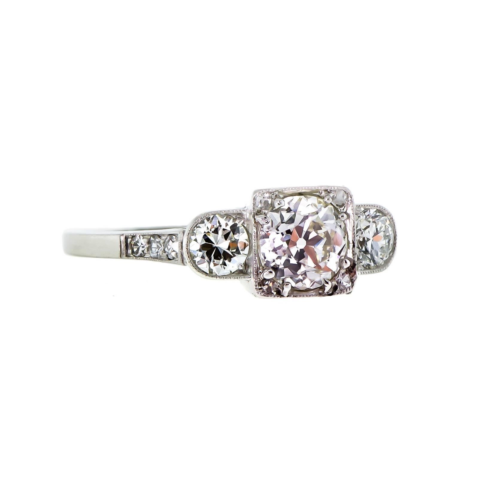 Art Deco platinum diamond three stone diamond ring centrally set with one Old European Cut diamond weighing approximately .97 cts, 6.20 6.20 X 3.99 VS-1, K , two bead set Old European cut diamonds approx. total weight .50 ct. , 4.00 - 3.90 x 2.60 mm