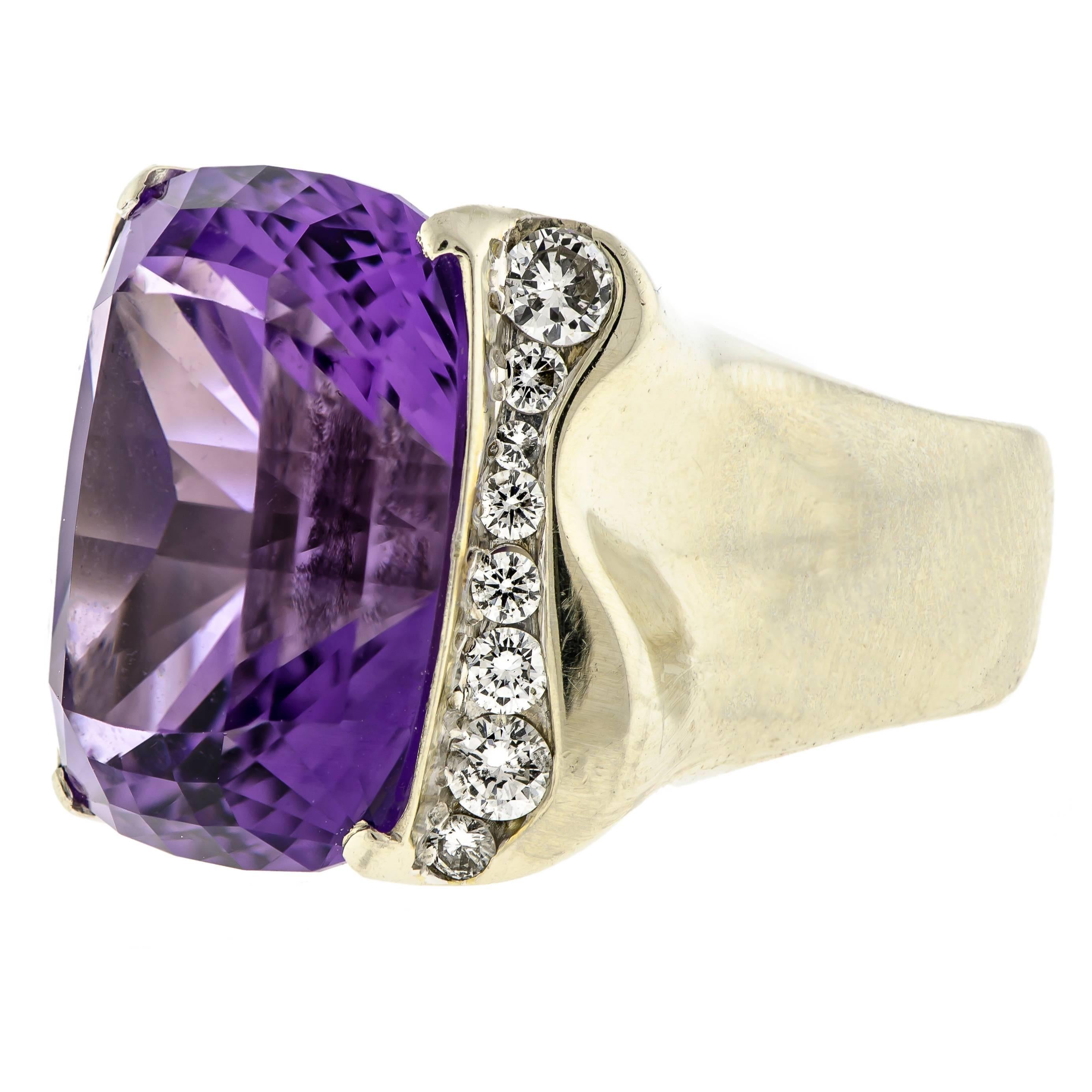 A White Gold, Amethyst and Diamond Ring, containing one cushion cut amethyst measuring approximately 20.28 x 15.54 x 13.93 mm and weighing approximately 20.50 carats, the shoulders accented with 16 round brilliant cut diamonds weighing approximately