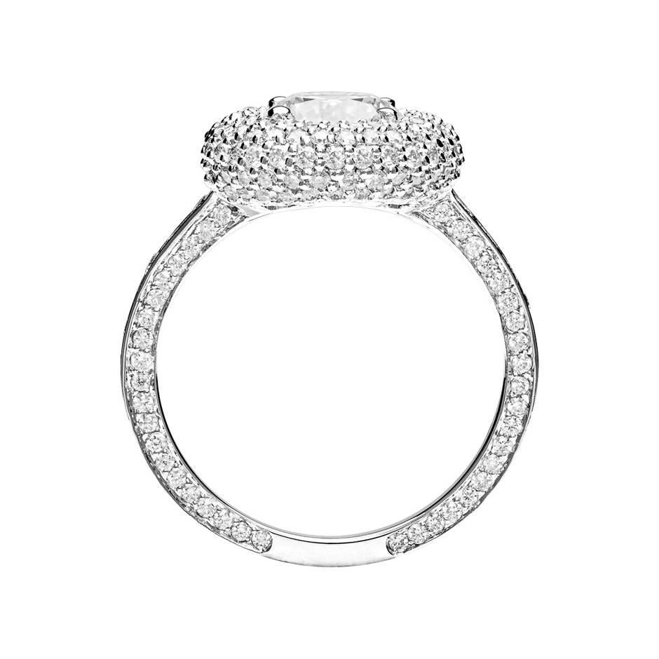An exquisite diamond ring with a central 1 ct diamond, beautifully framed by captivating pave brilliants. The main diamond is a classic prong-set brilliant-cut diamond (E VVS1). The ring is made from 950 platinum and is available in 18K white gold,