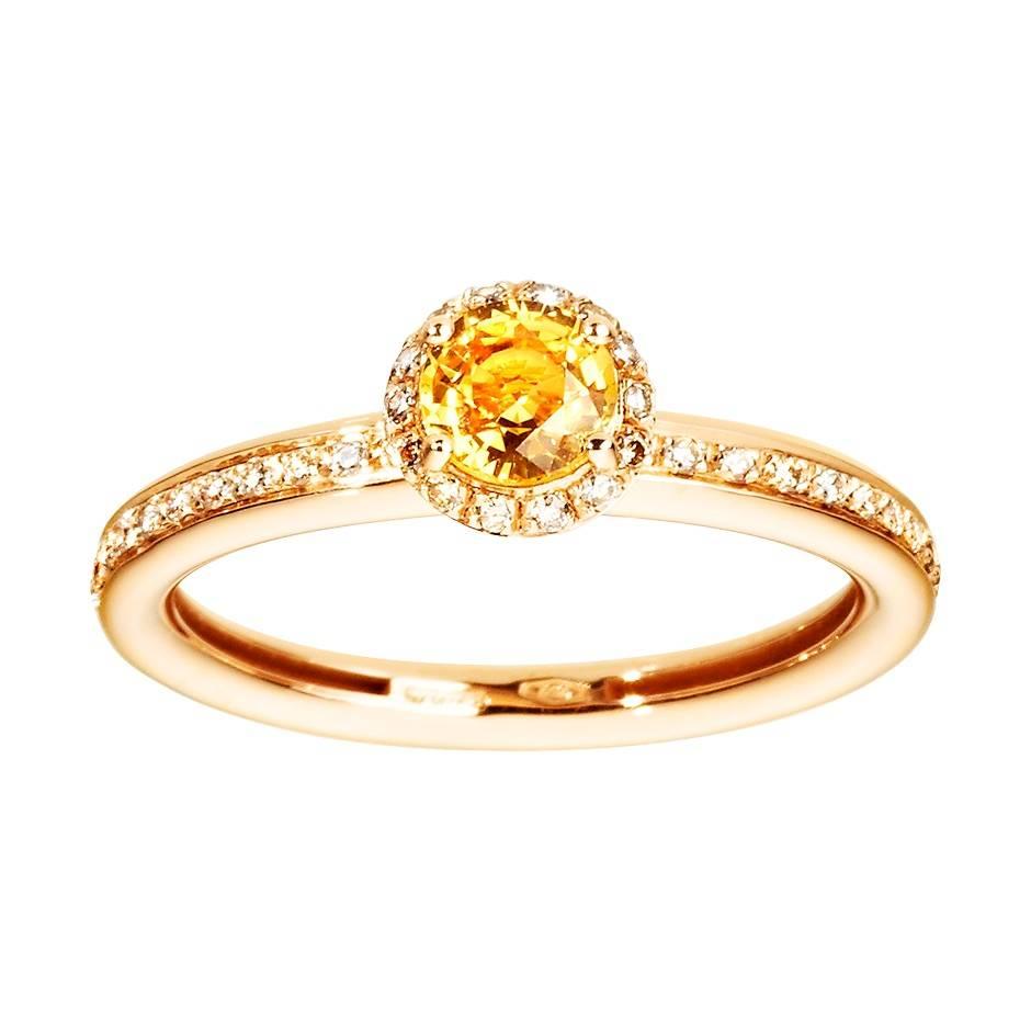 This delicate rose gold ring features a striking yellow sapphire with a frame of white diamonds and a channel-set white diamond band. 

Details
Ring size: 58 (US size 8.5)
Band width: 2.9 mm
Yellow sapphire: 5 mm in diameter (approx. 0.55