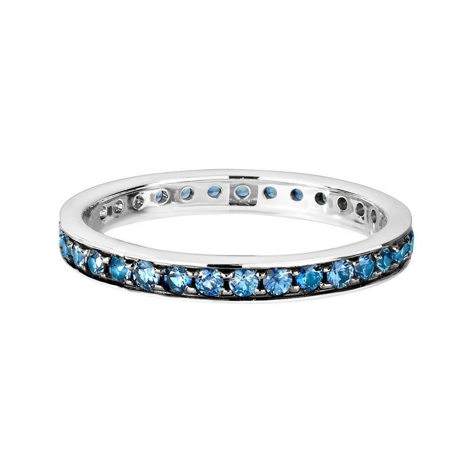 This delicate 18K white gold eternity ring features enchanting channel-set blue sapphires (0.02 ct each) full circle. The ring is a size 54 (US 6.5) and measures 2.7 mm in width.