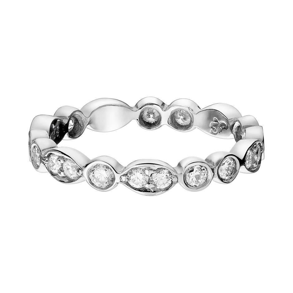 This 950 platinum eternity ring features diamonds with a total weight of 0.62 ct. The diamonds are intricately set in singles or pairs along the delicate band. The ring is a size 50 (US size 5) and has a width of 3.8 mm.