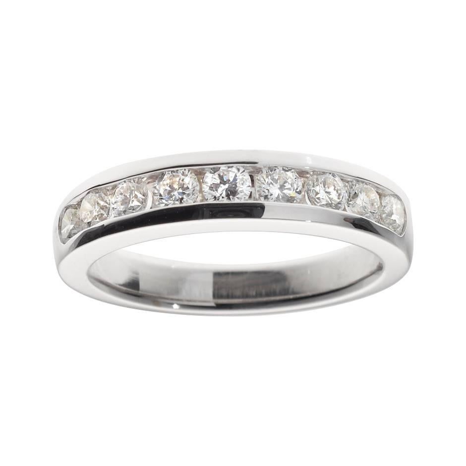 This delicate eternity ring features a total of 9 brilliant-cut diamonds (0.015 ct each, G VS) in a refined channel setting. The ring is crafted in 18K white gold and is a size 53 (US size 6.5).
