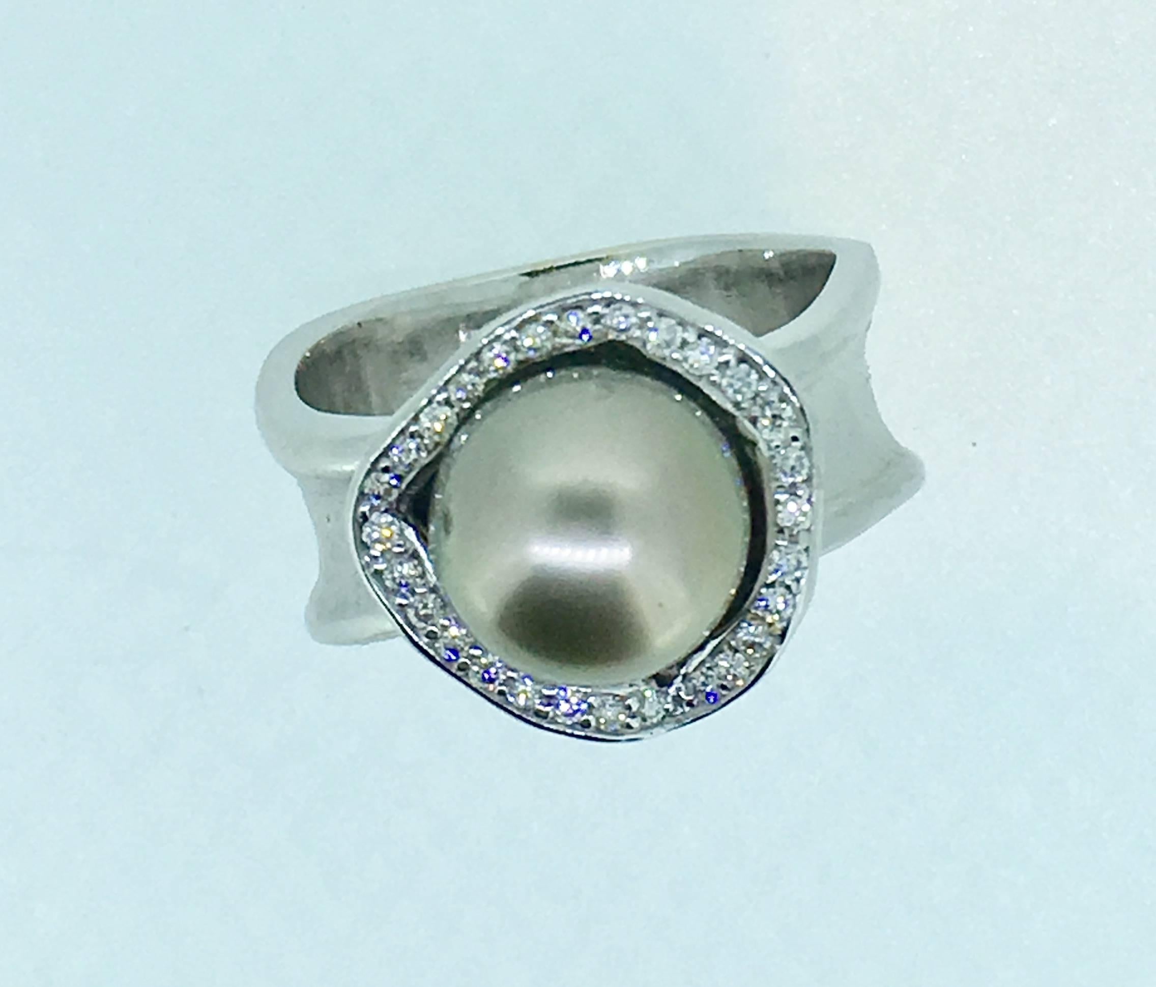 This piece includes a beautiful  Baroque pearl, its one of a kind unique ring signed SVG and has 0.25 cts diamonds.