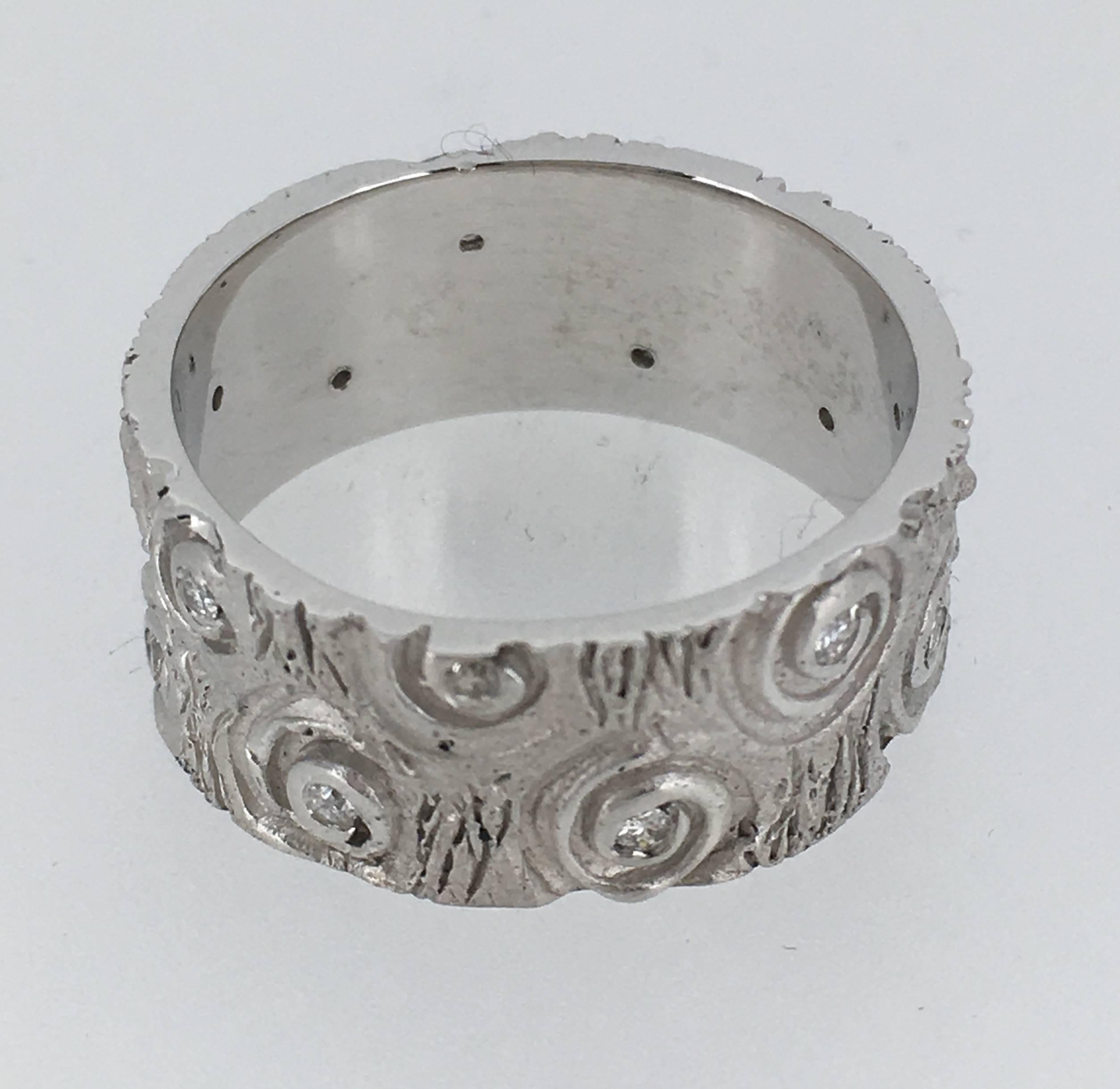 This is a gorgeous engraved wedding Ring with 13 diamonds of total 0.15ct
It's made of 9.4 gr white Gold.

This unique piece is signed SVG designed and made by Steven in our Antwerp workshop .

The size of the ring is 58 but we can size it to
