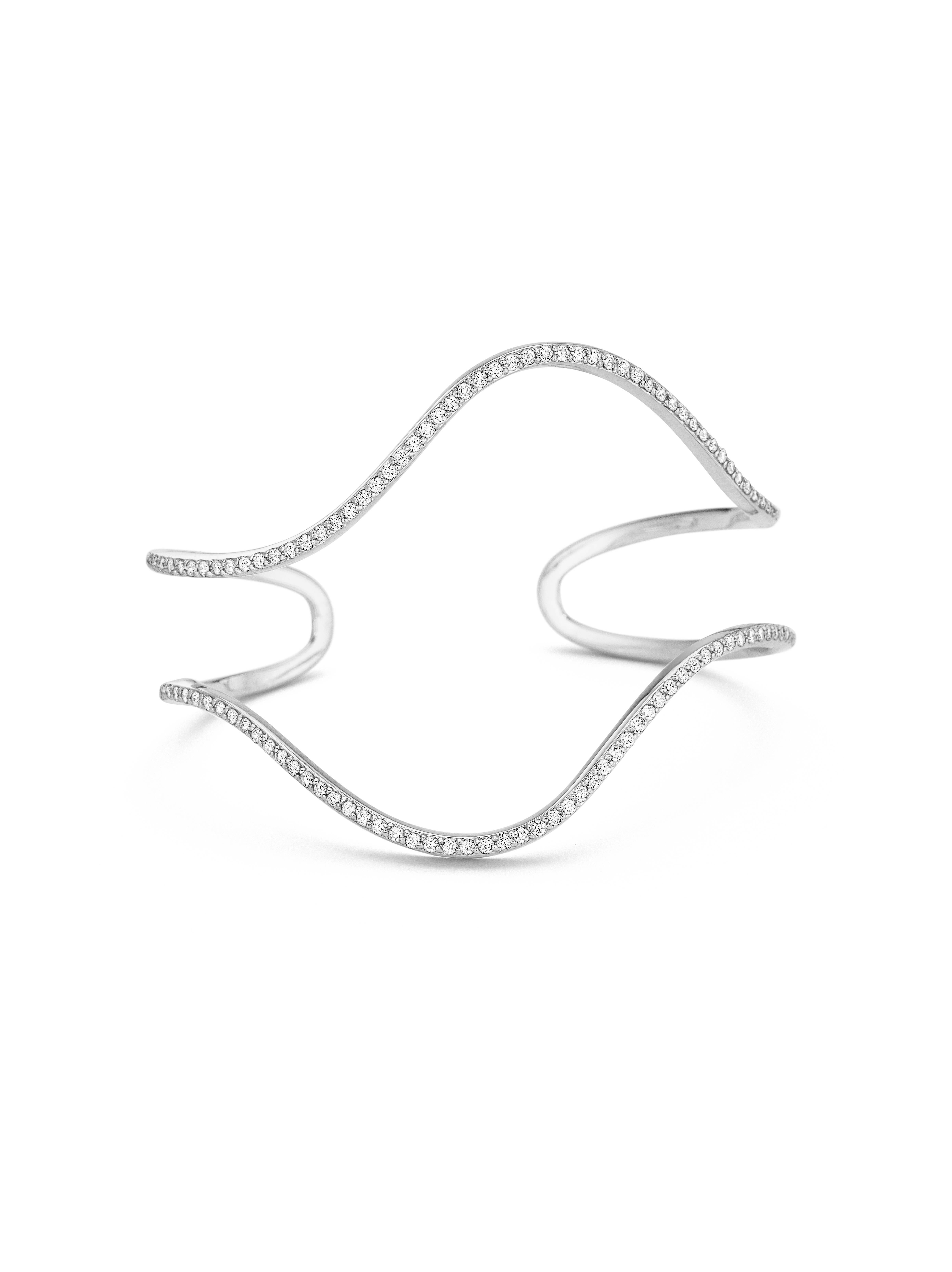 This diamond statement cuff is both elegant and chic, designed to take you from day to night. Made of 18k gold and 1.43 carat of diamonds, sculptural lines create a subtle wave effect. This unique cuff is part of a limited edition collection and
