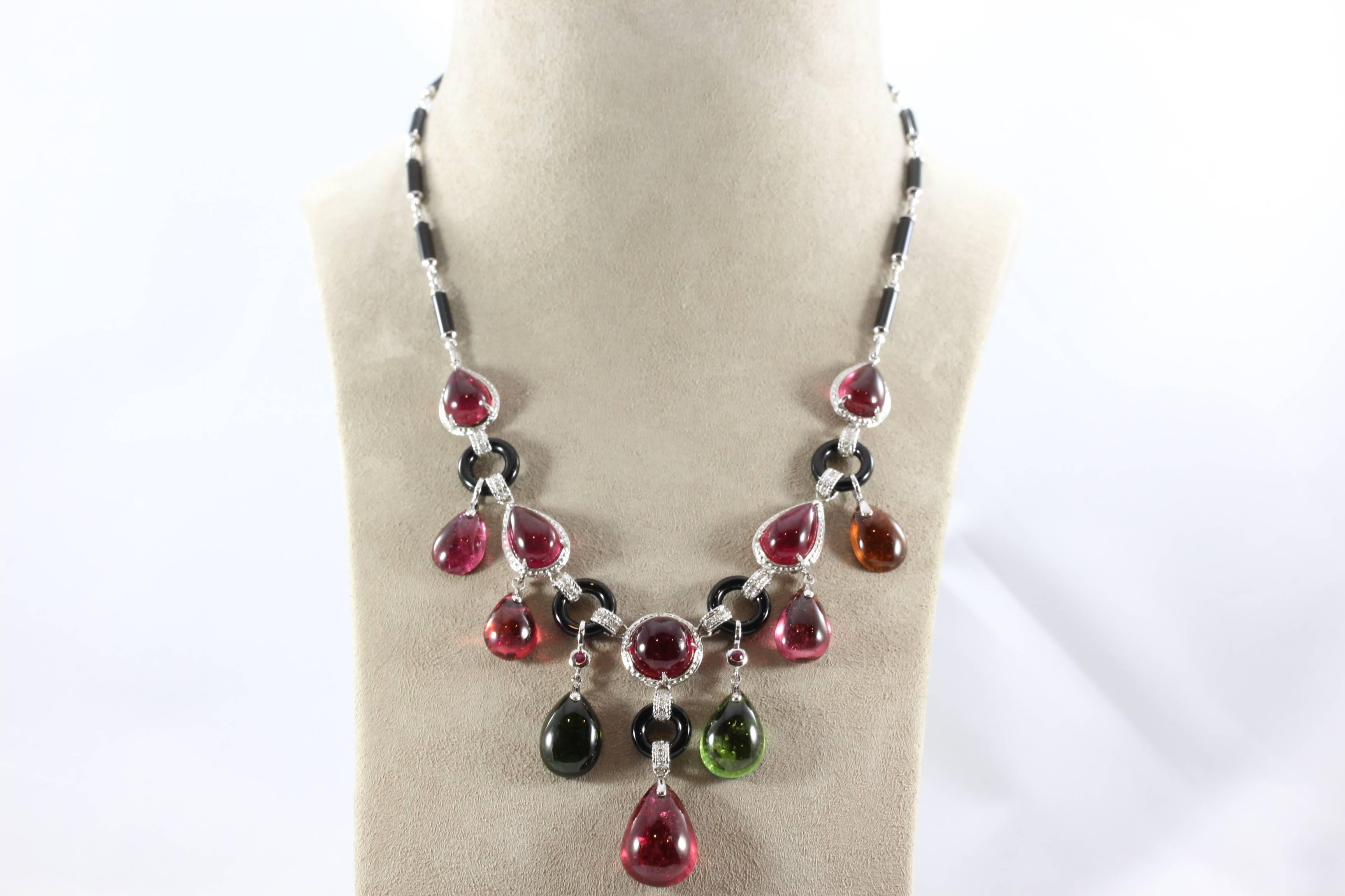 An impressive gem studded necklace featuring close to 40 carats of gem quality cabochon tourmaline. Studded with diamonds and designed with black onyx and 18K white gold, this necklace is for the bold looking to make a statement!  

Necklace Length: