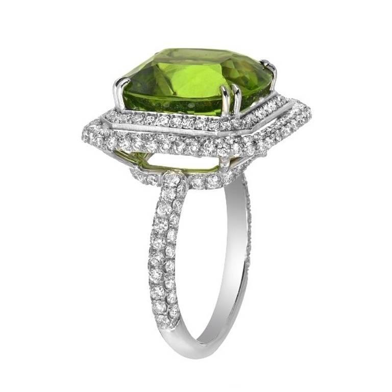 A stunning ring featuring a 13.90 peridot gemstone with 2.18 carats of full-cut diamond,set in platinum. 
