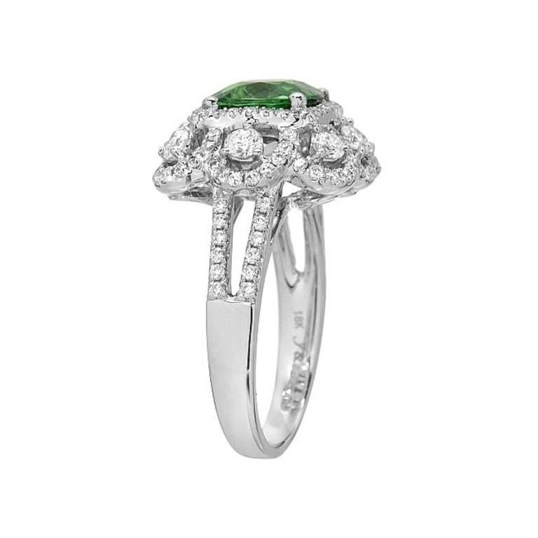 This ring features a fine tsavorite gemstone weighing 2.53 carats. The gemstone is surrounded and accented by 1.30 carats of full-cut diamonds, set in 18K white gold. A ring for someone who understands and appreciates fine colored gems.

Ring size