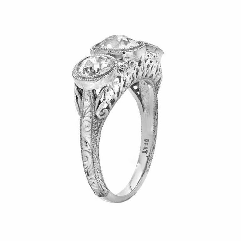 A fabulous Art Deco piece which features 3 large European cut diamonds as well as 4 smaller diamonds in between the center and side diamonds, weighing a total of 3.00 carats. Set in platinum.

Currently ring size 7